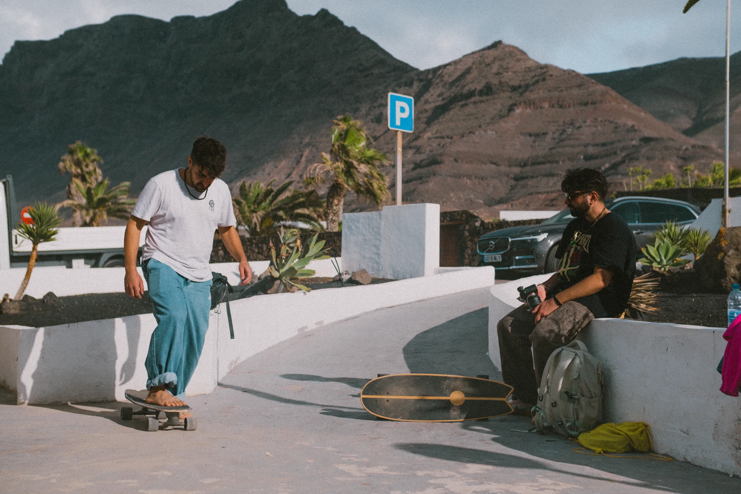 Ieser and Iair with two skateboard next to Lanzasurf school