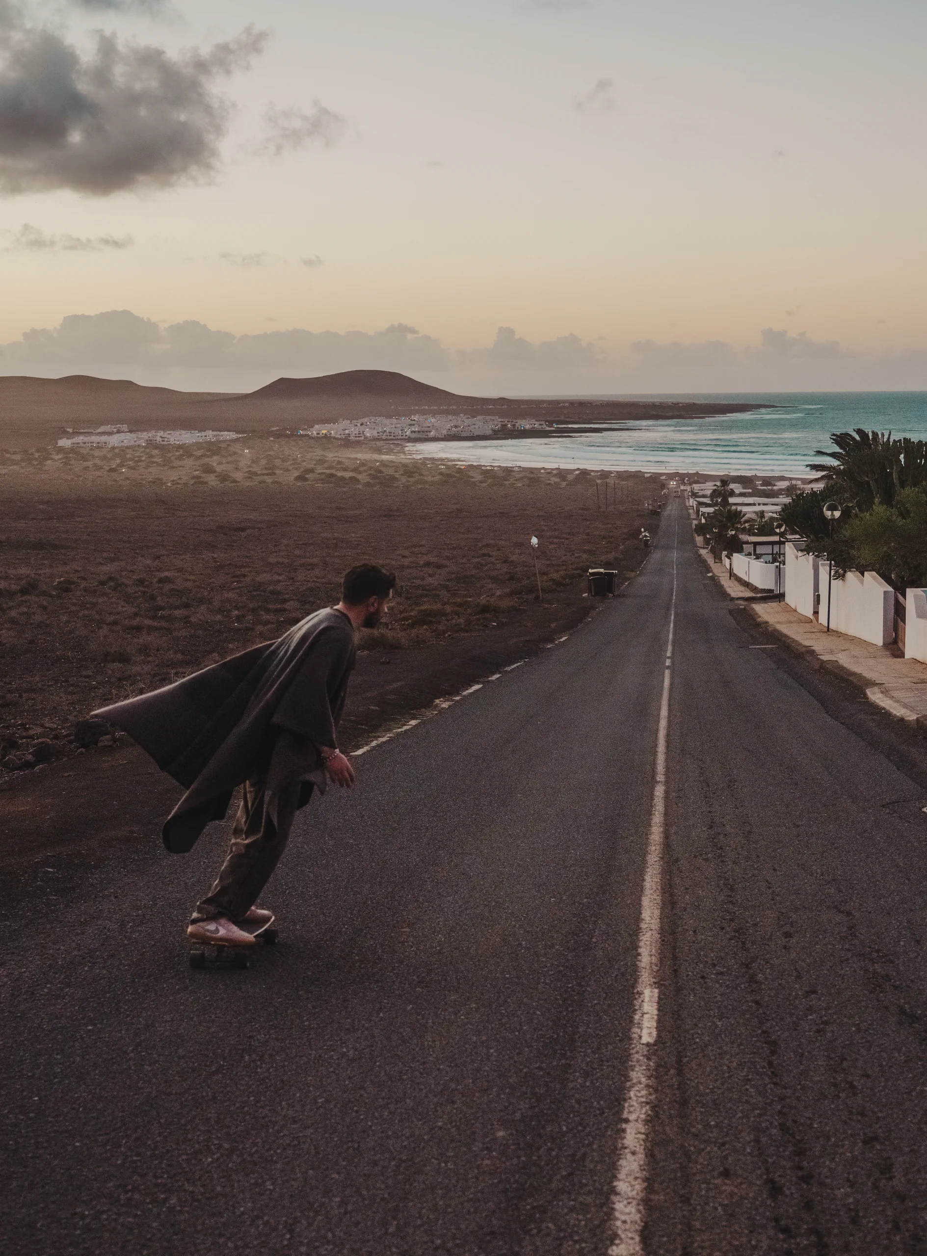 Iair going down a road with a skateboard