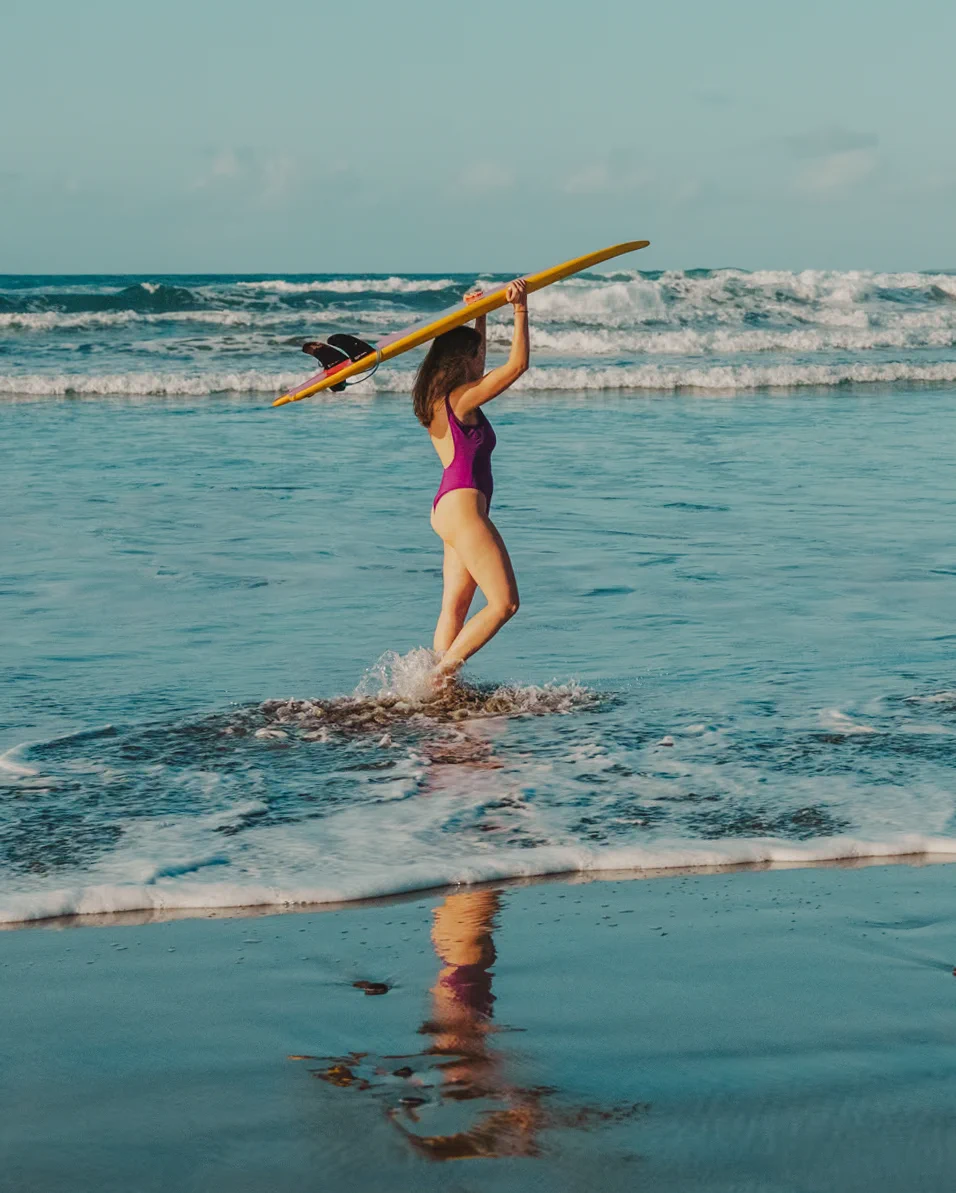 Letizia with a board above her head in Famara