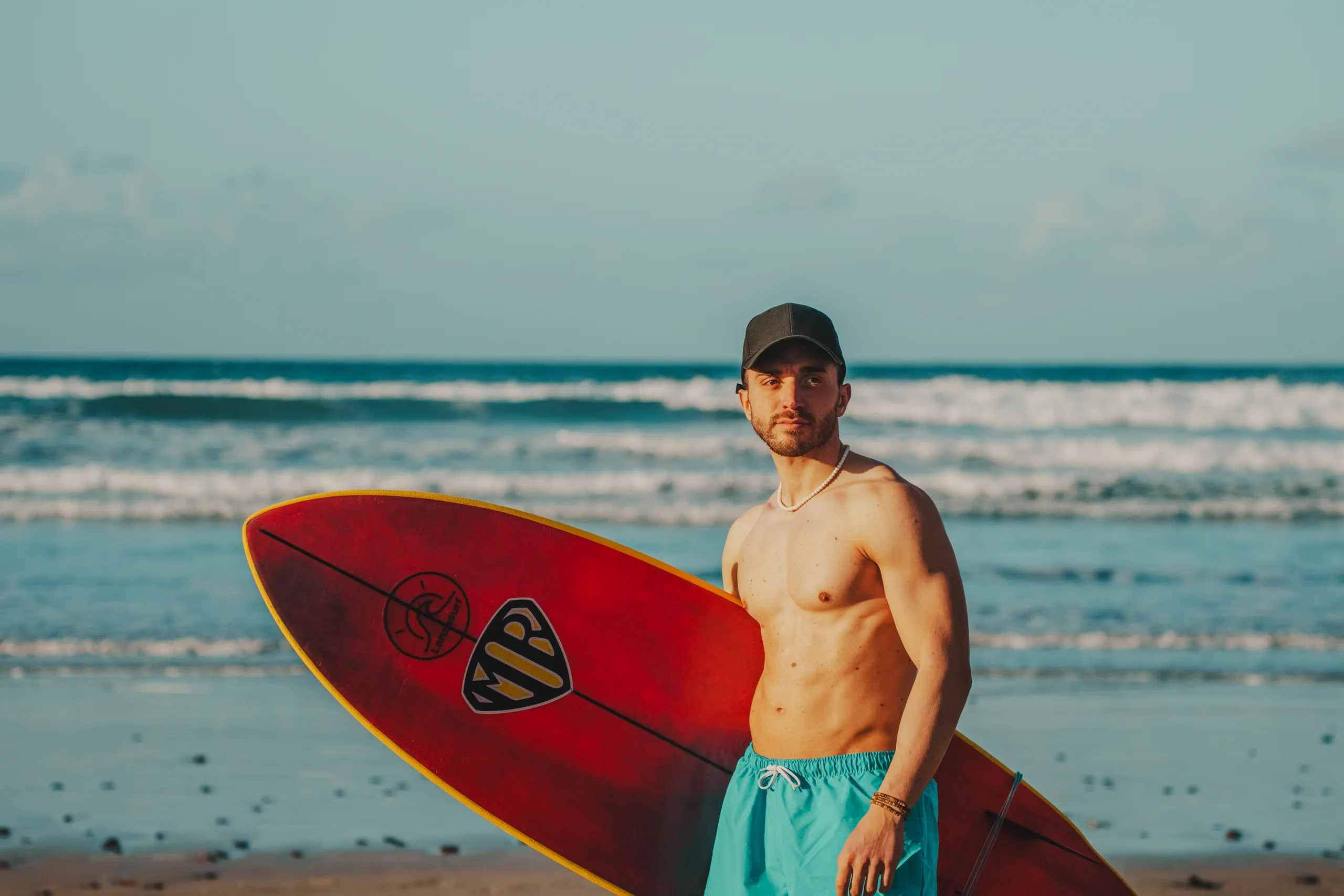 Stefano holding a surfboard by Lanza Surf in Lanzarote