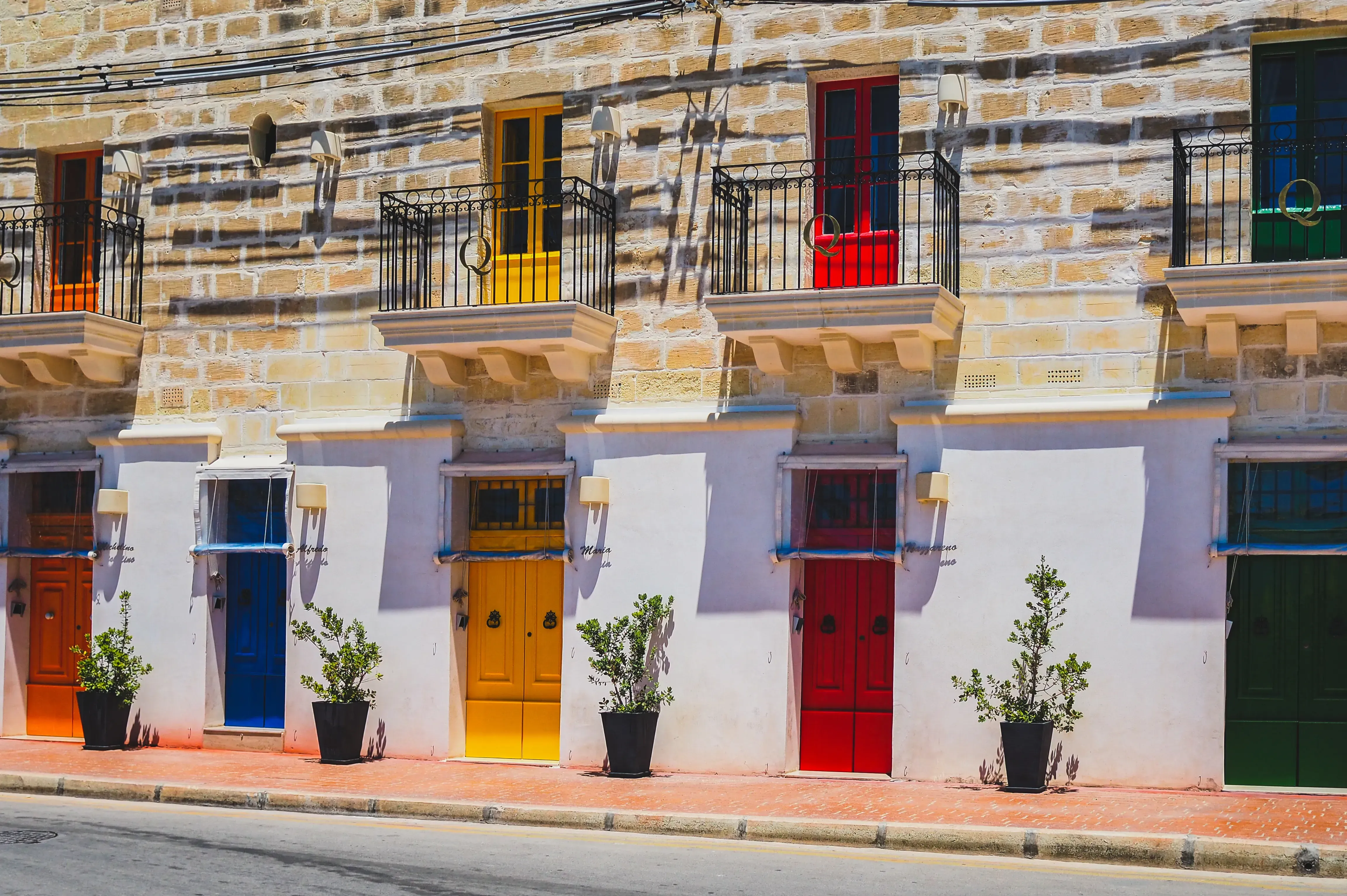 Brightly painted traditional houses lining the harbor of the southern village (Marsaxlokk).