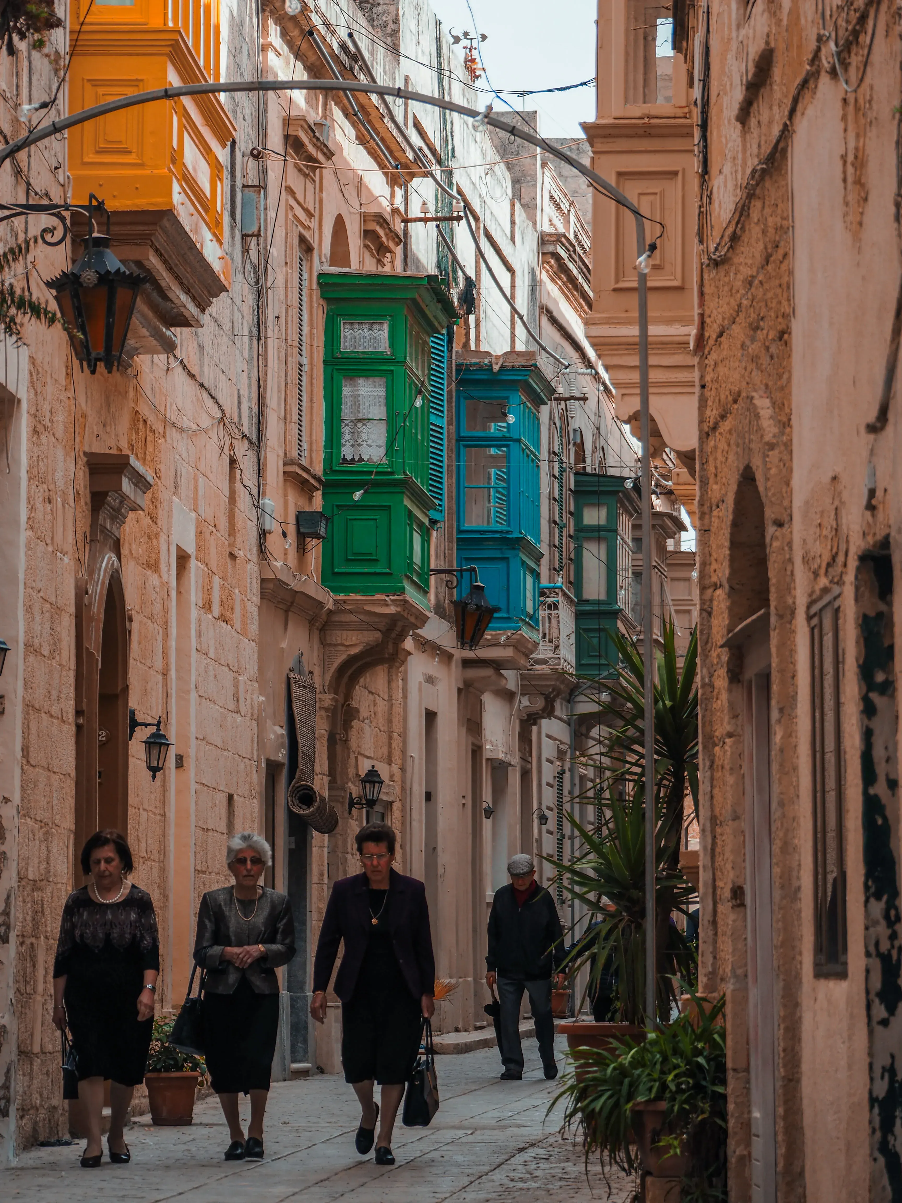 People walking along the peaceful, pedestrian streets inside the Mdina citadel.