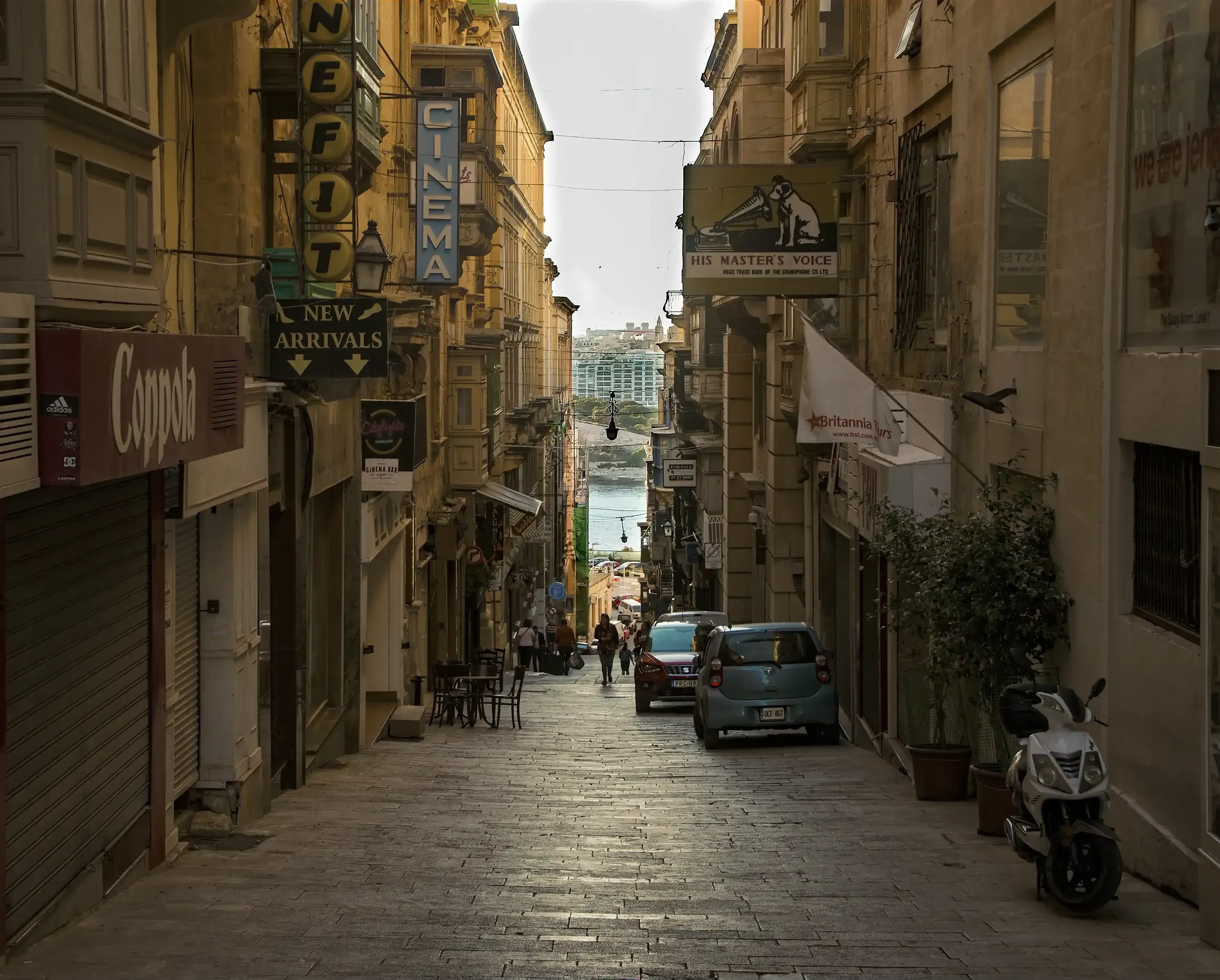 Mdina street view with the distant Mediterranean Sea visible in the background.