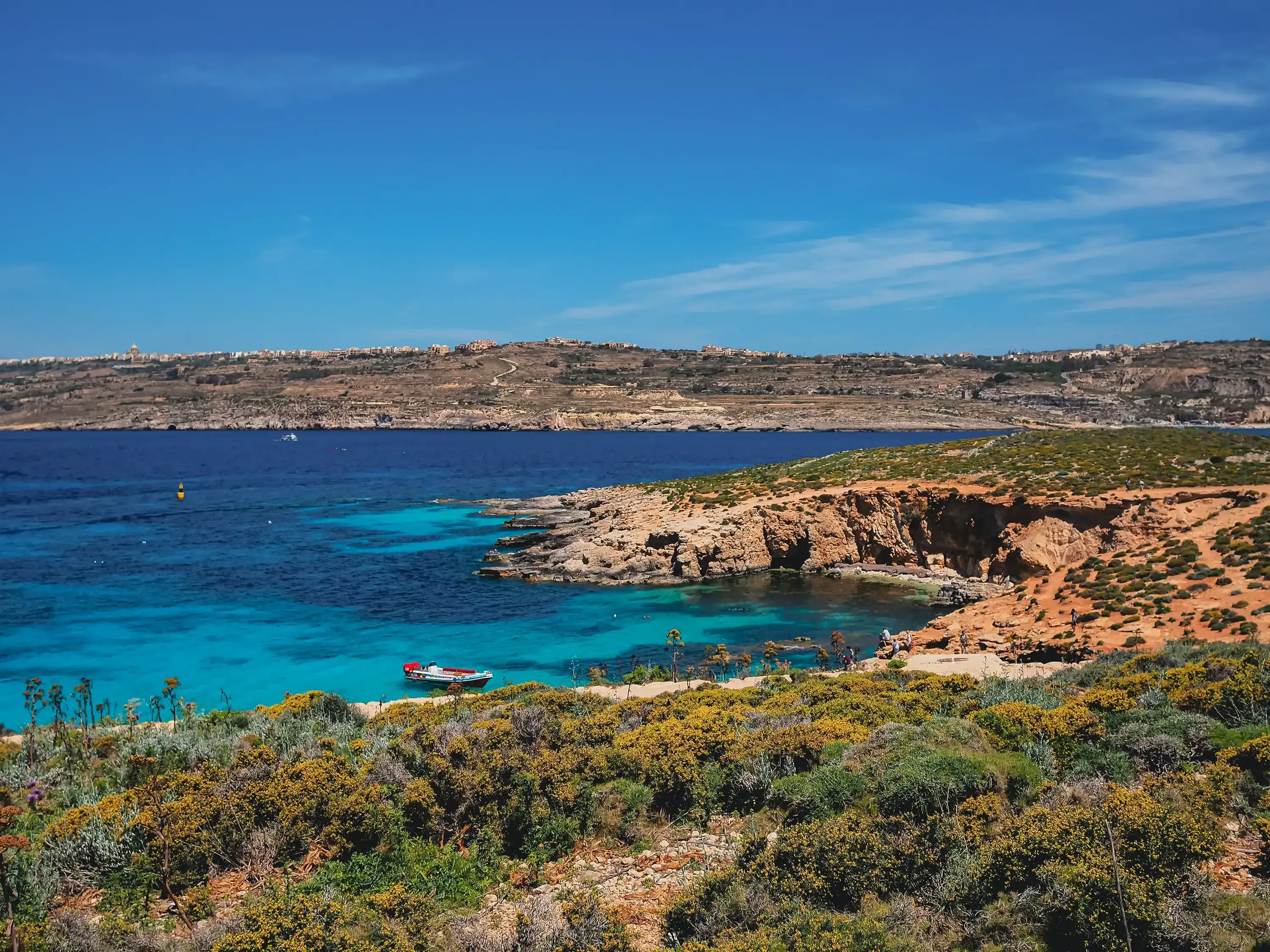 View of a secluded sandy or rocky beach on the island of Malta.
