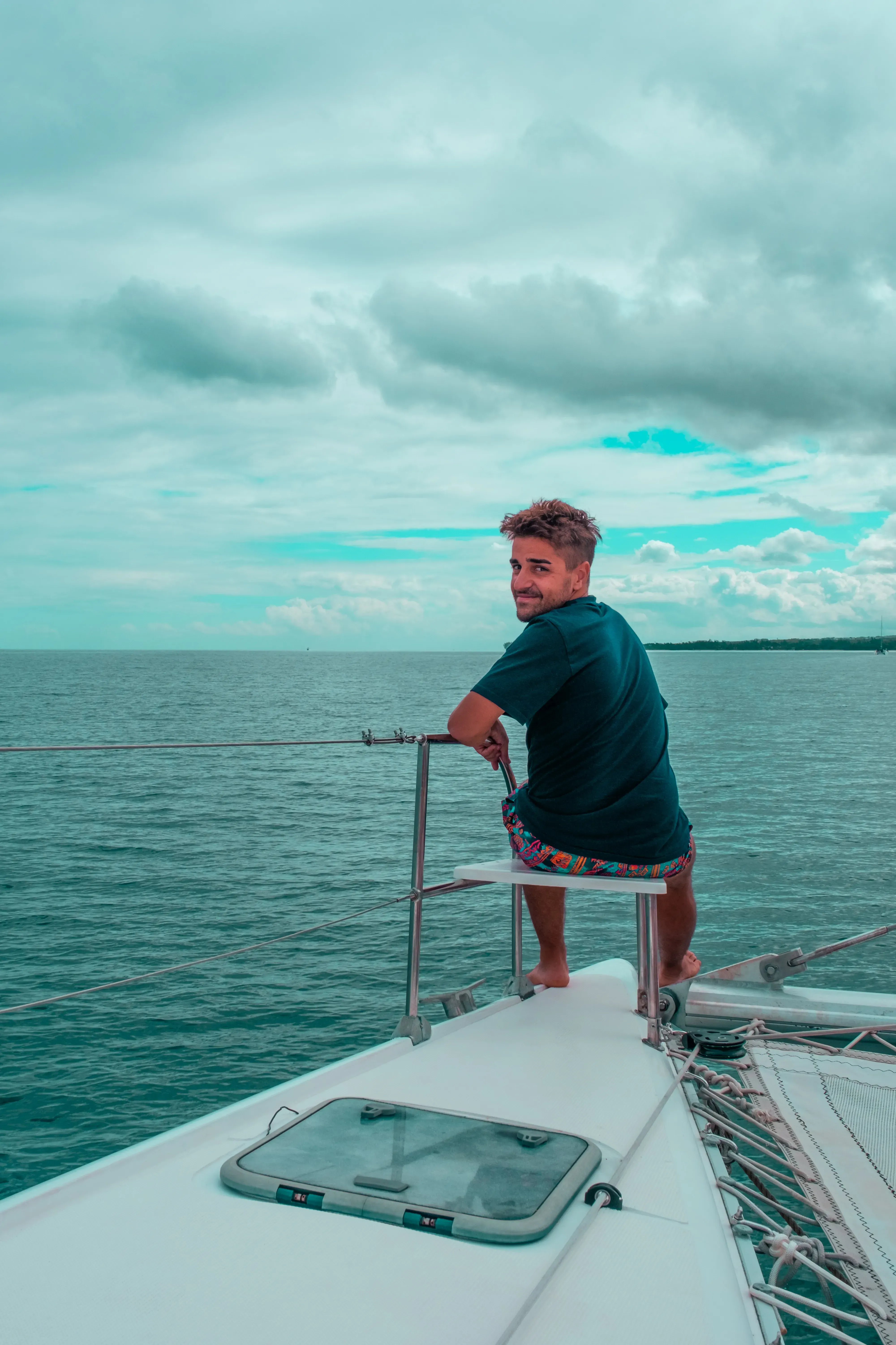 Ieser sitting comfortably on a deck chair or seat aboard the catamaran sailing near Mauritius.
