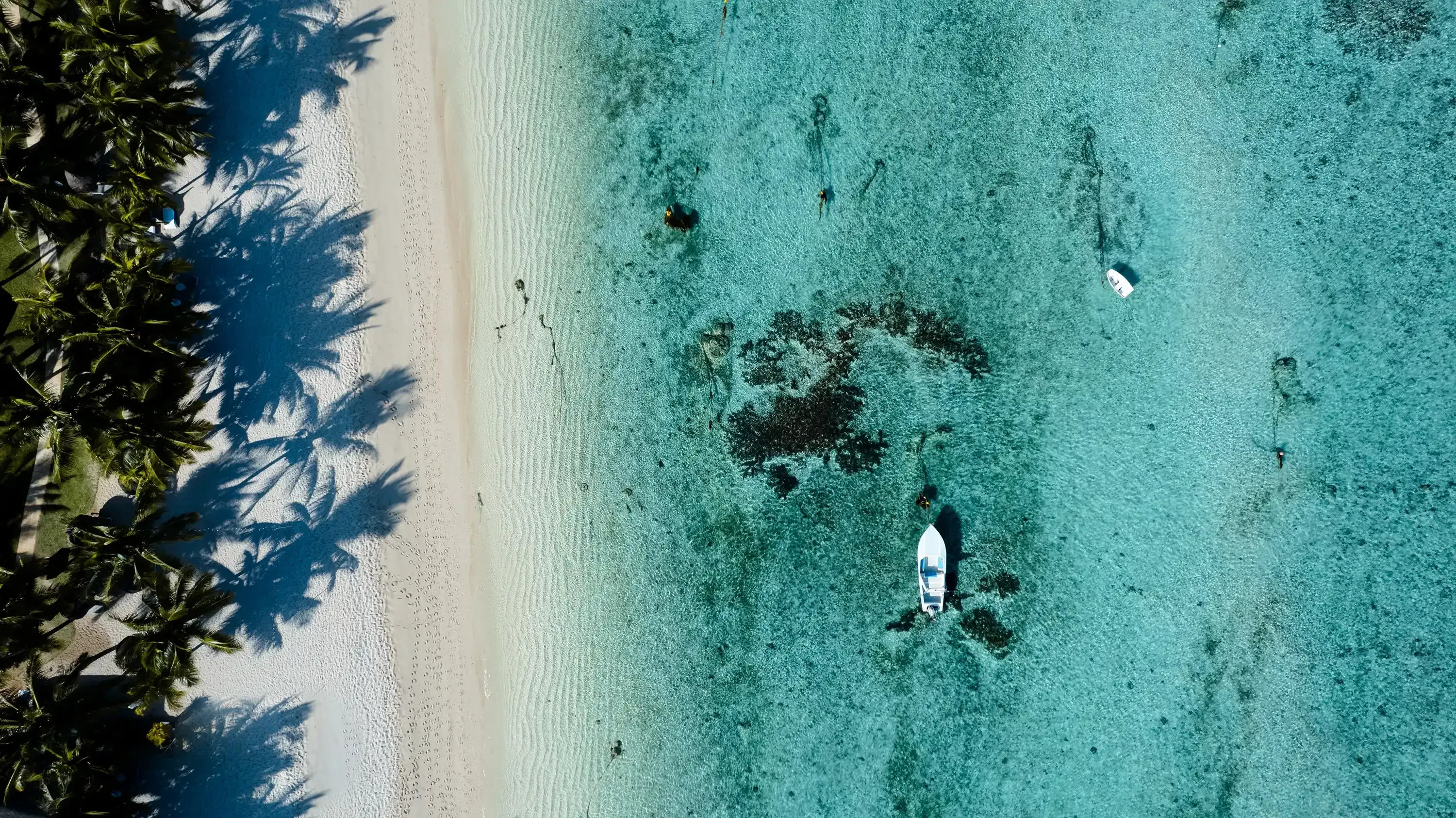 An expansive aerial drone view showcasing the entire curve of Le Morne beach and the adjacent lagoon.
