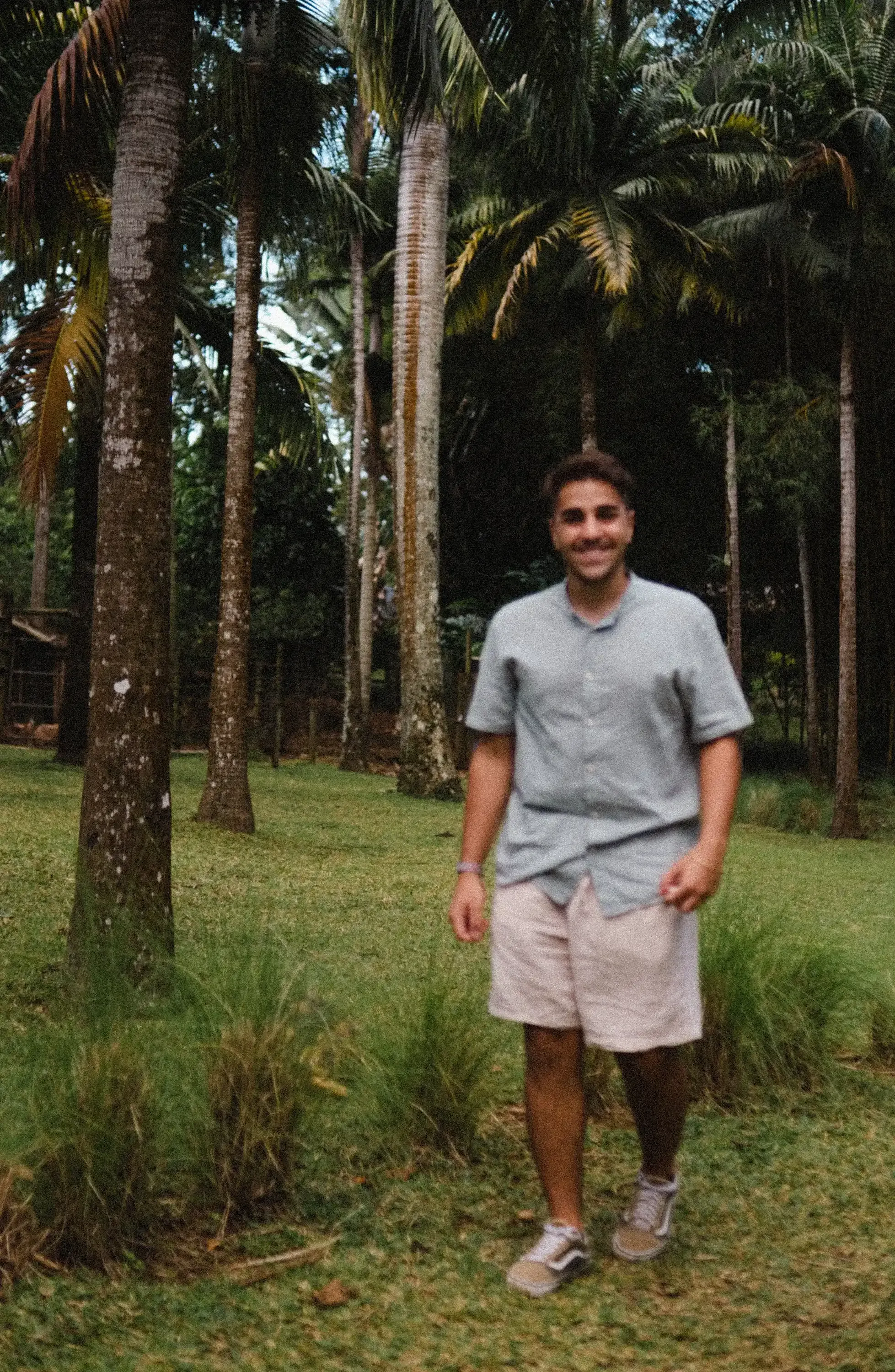 Ieser walking along a path within a vibrant, tropical botanical garden.