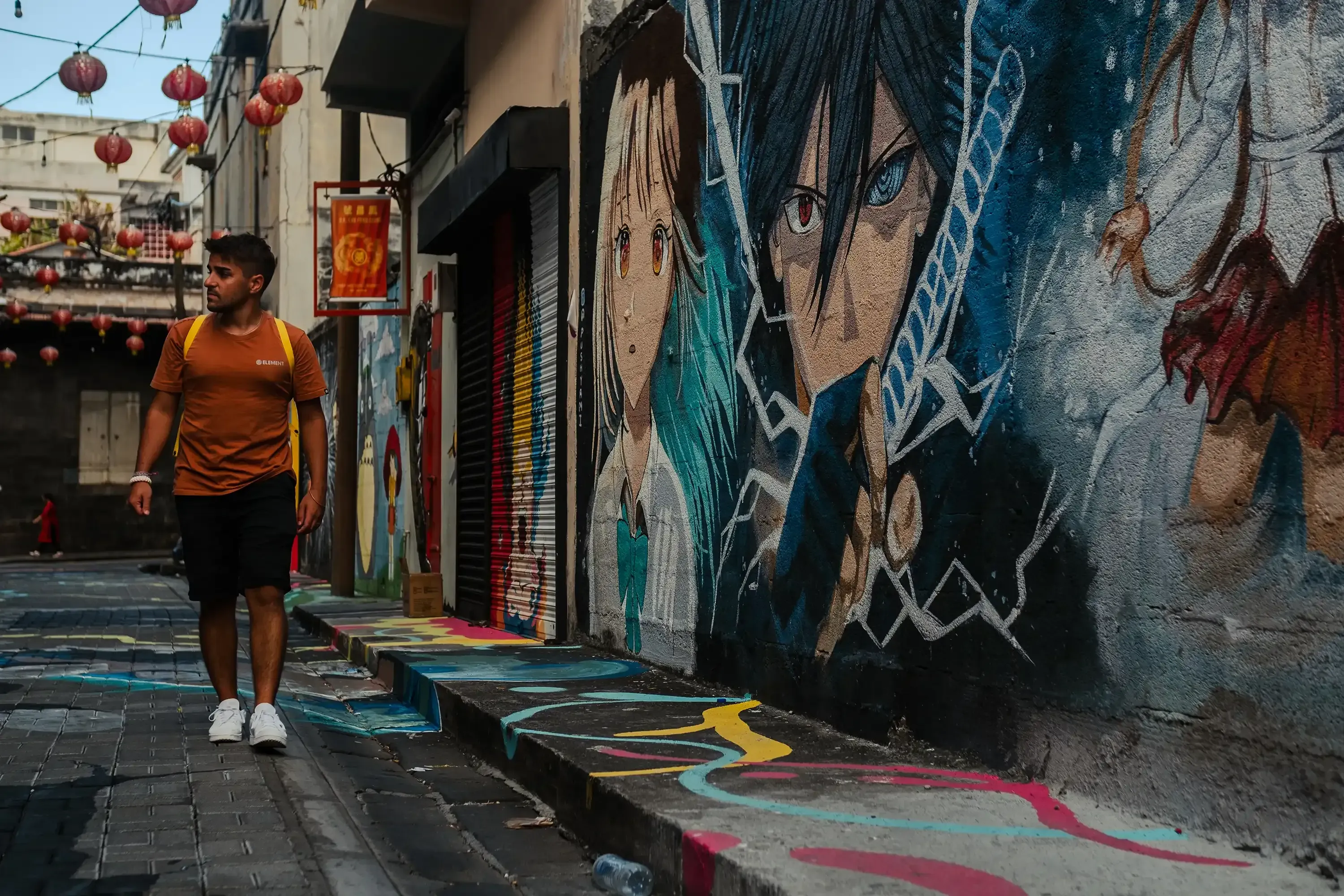 IIeser walking down the busy Mahebourg street, capturing the street life of Port Louis.