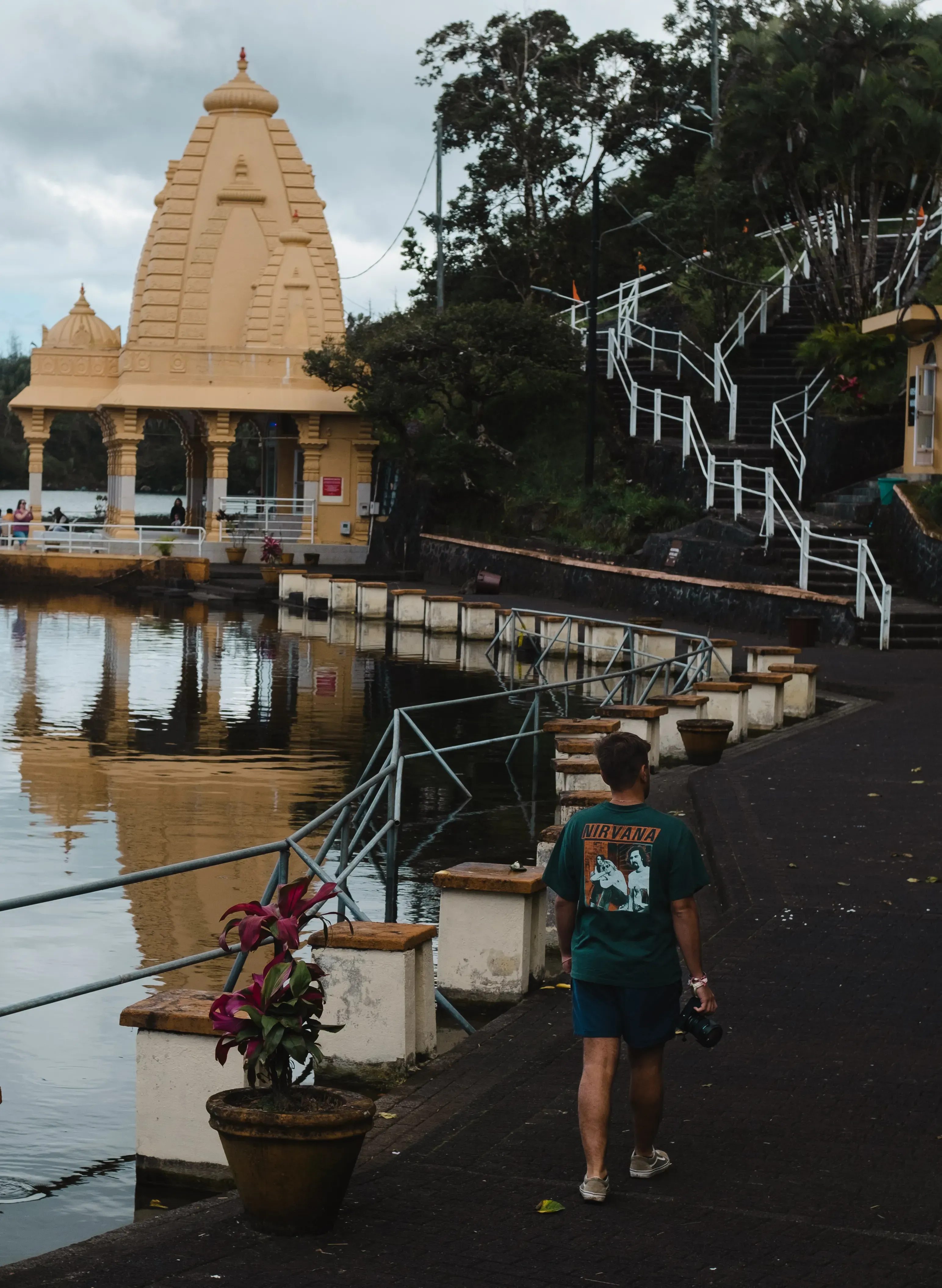 Ieser walking along the pathway toward the sacred Grand Bassin crater lake (Ganga Talao) and its large Shiva statue.