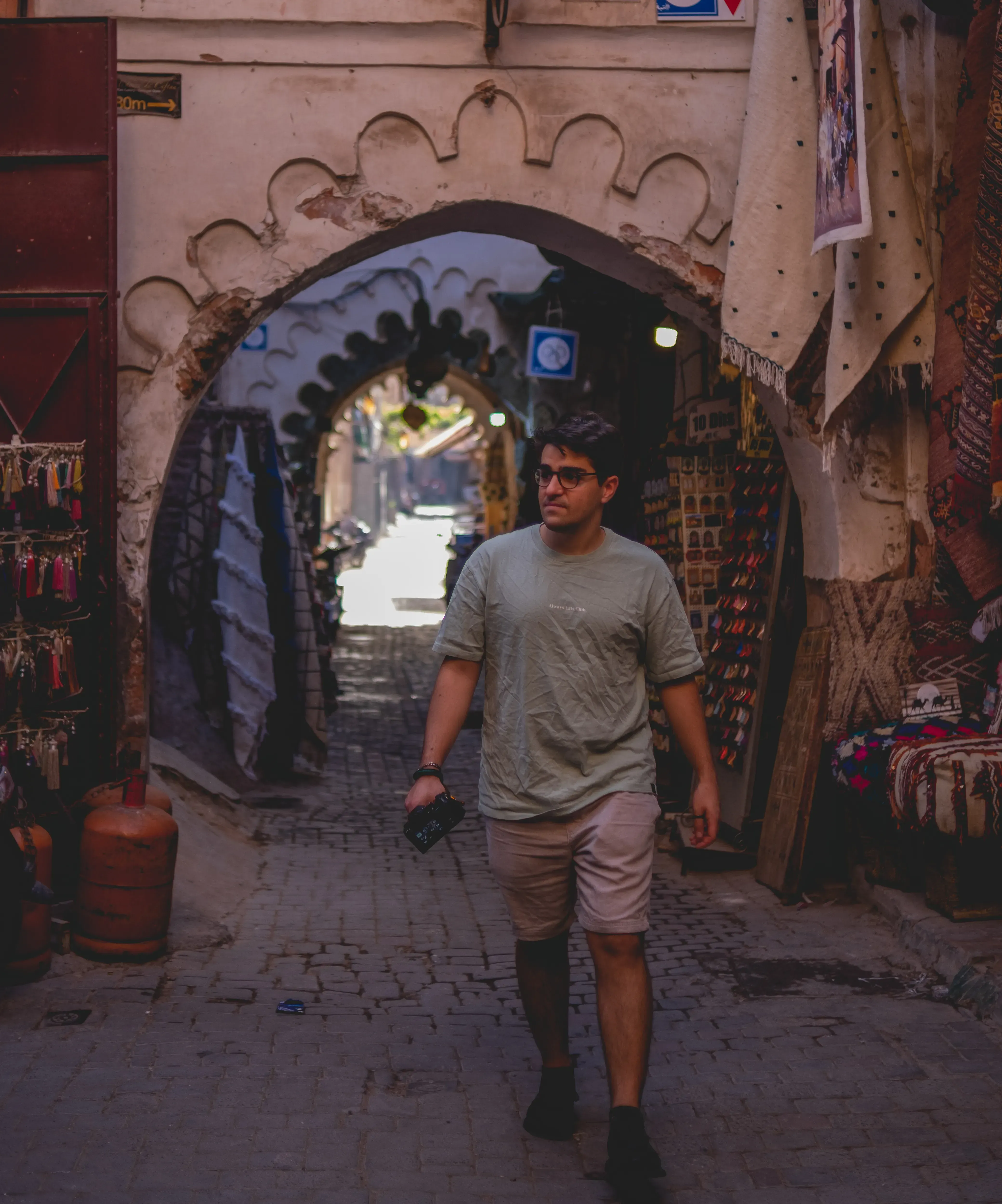 Ieser walking through the complex, winding alleyways of the Marrakech medina.