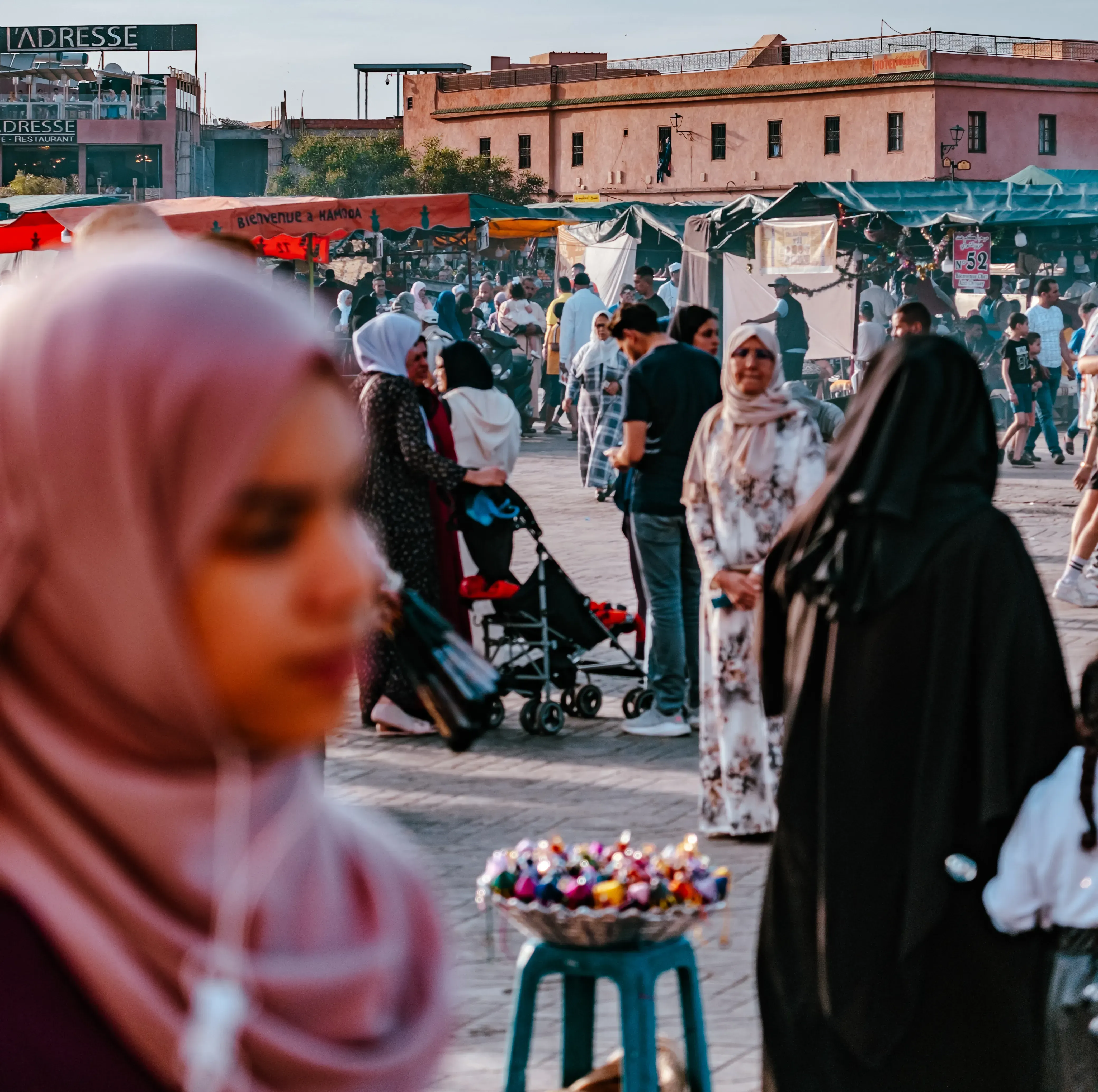 People gathering and interacting in the large public square (Jemaa el-Fna) in Morocco.