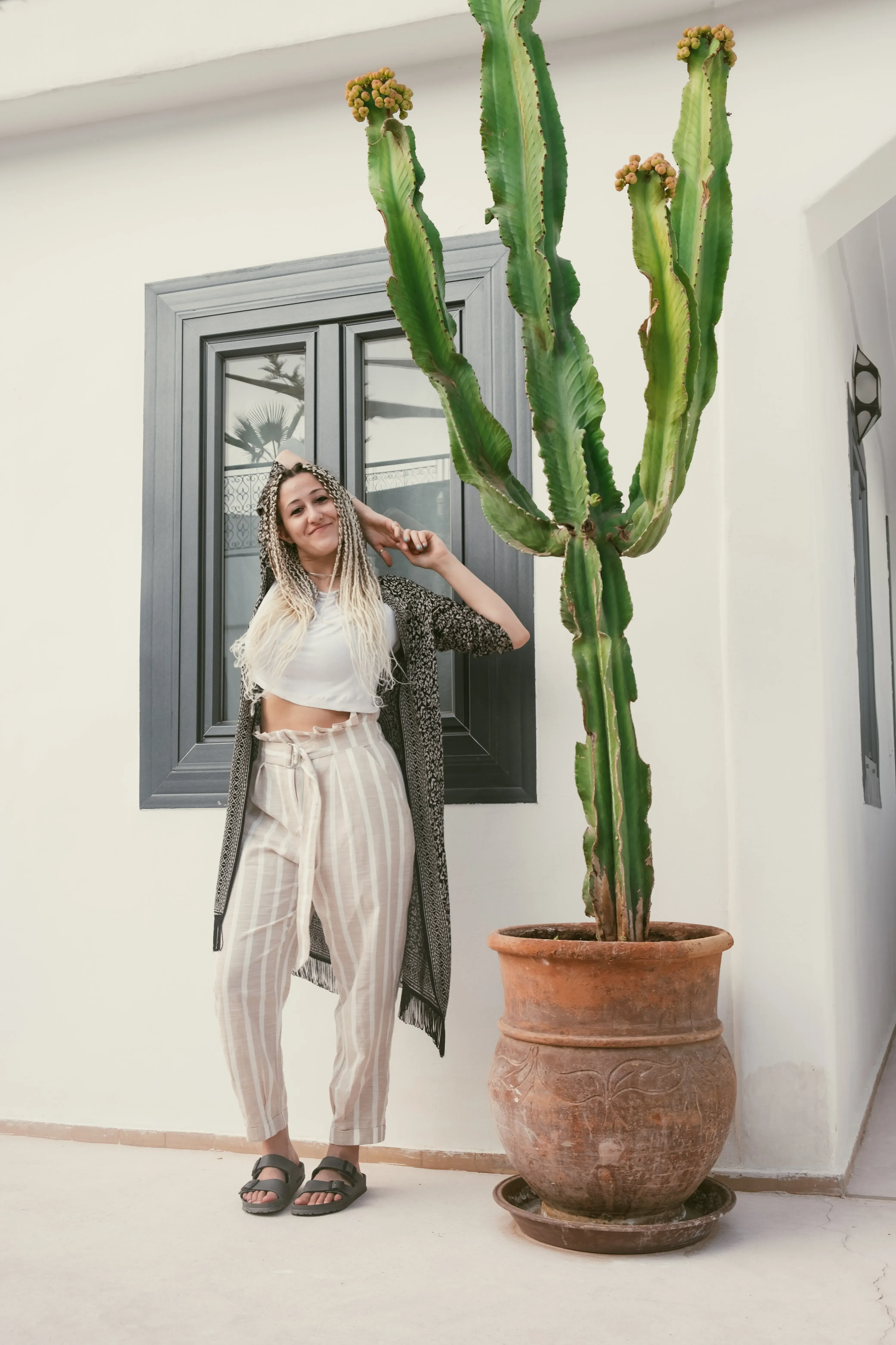 Letizia standing next to a large cactus plant.