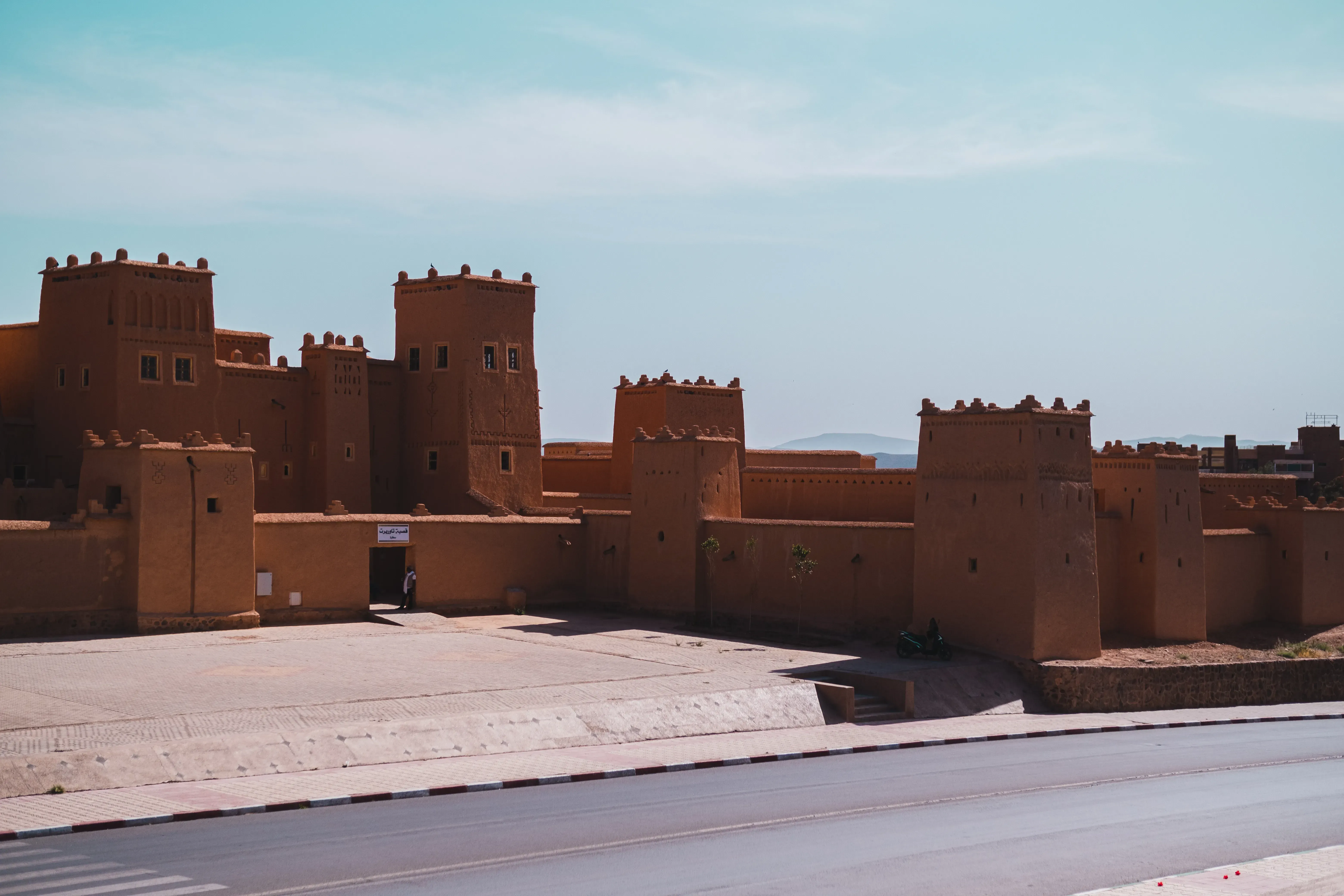 A large, traditional earthen-brick Kasbah or historic fortress structure.