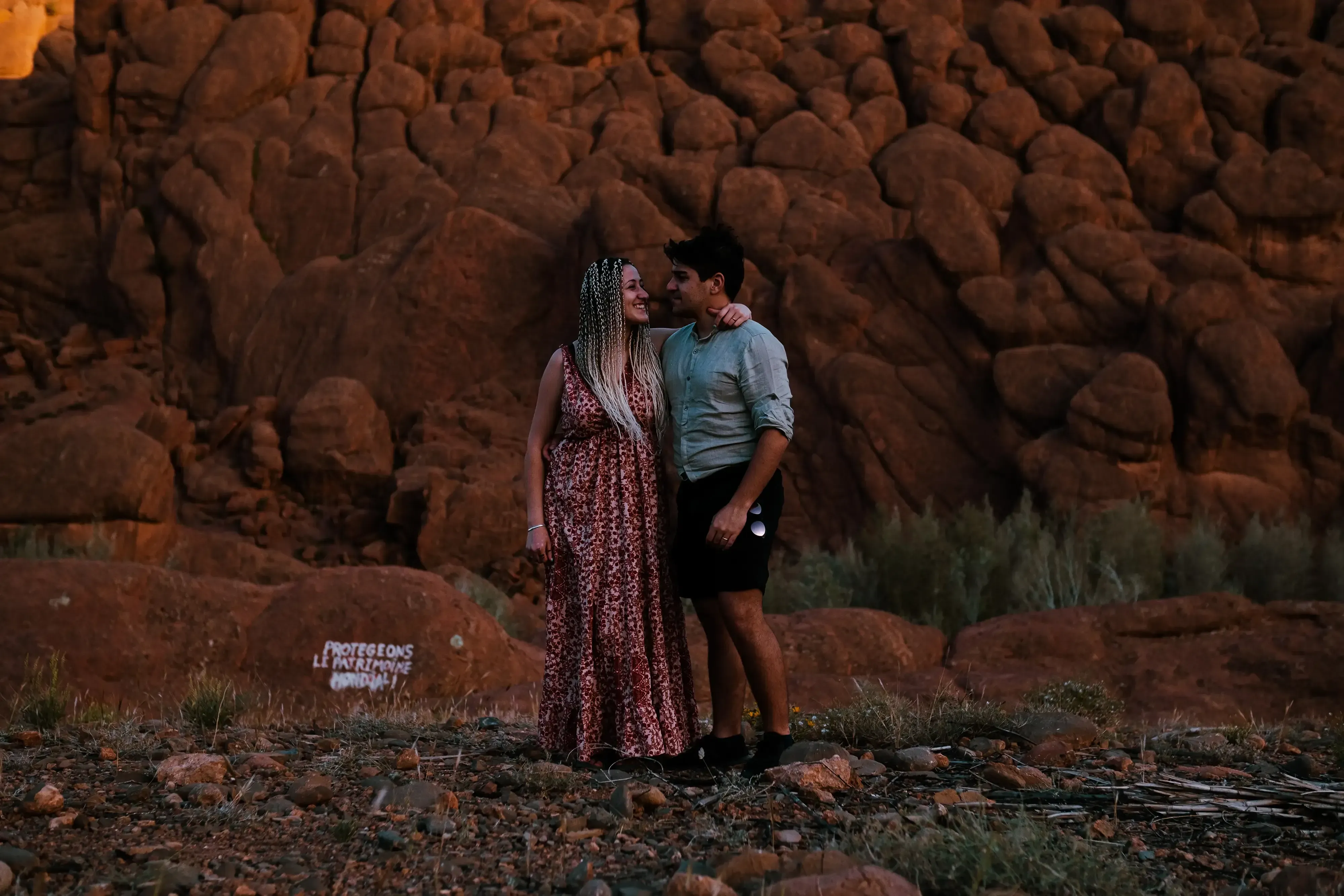 Ieser and Letizia standing near famous rock formations in the Moroccan natural park.