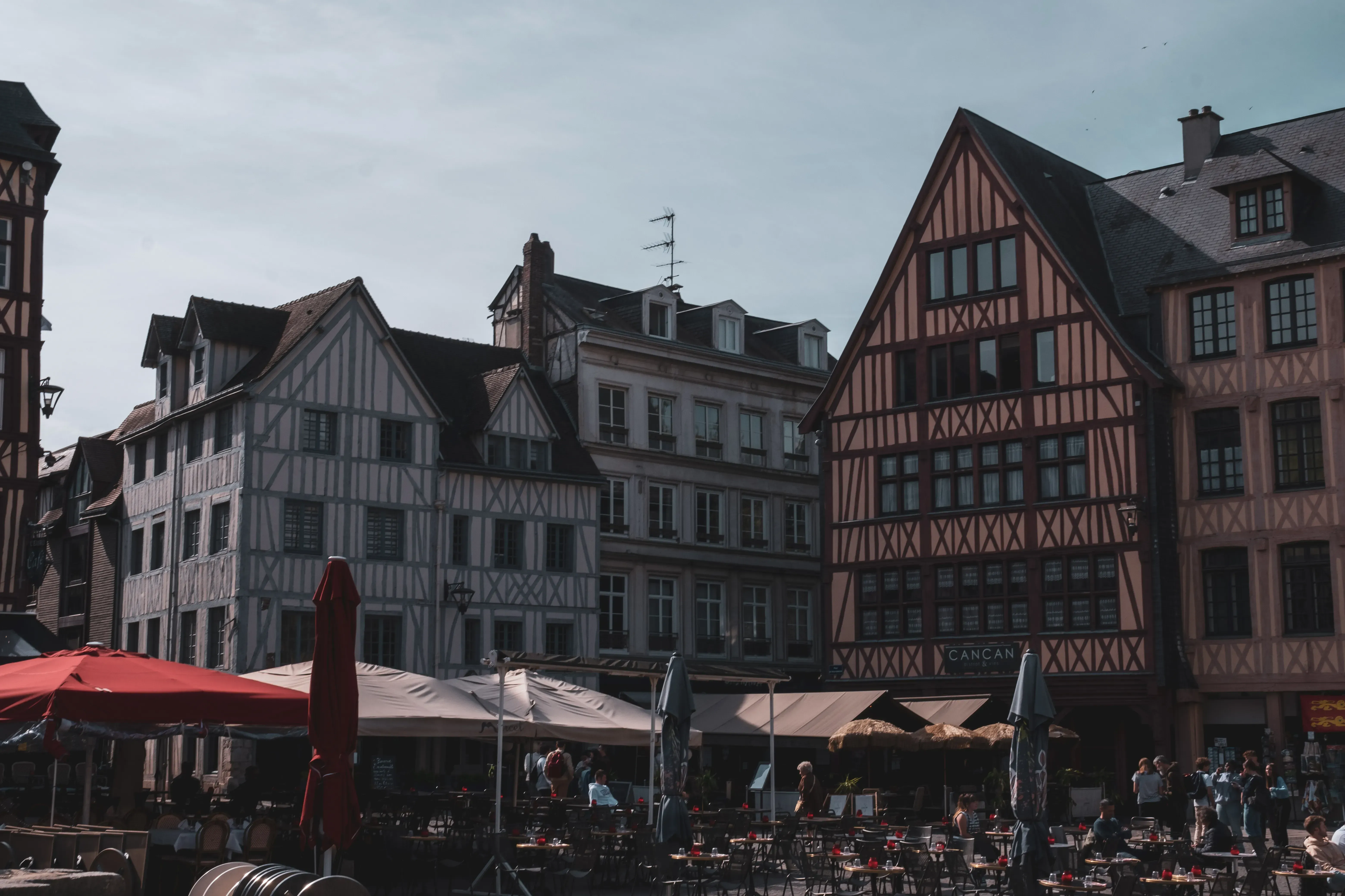 A wide shot of the main square in Rouen, featuring historic buildings and possibly the Gros Horloge.