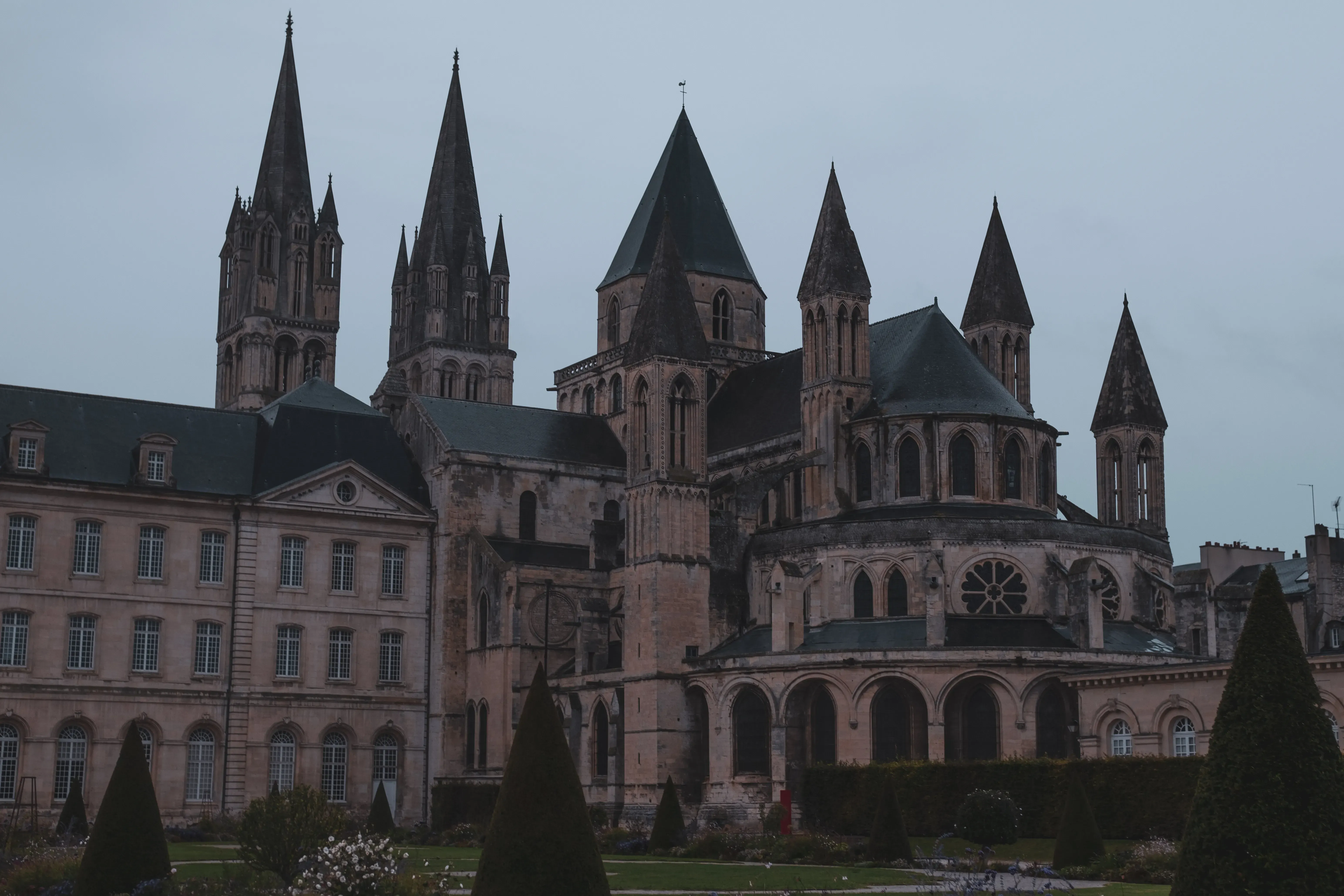 A vast, imposing Gothic or Romanesque cathedral dominating the skyline.
