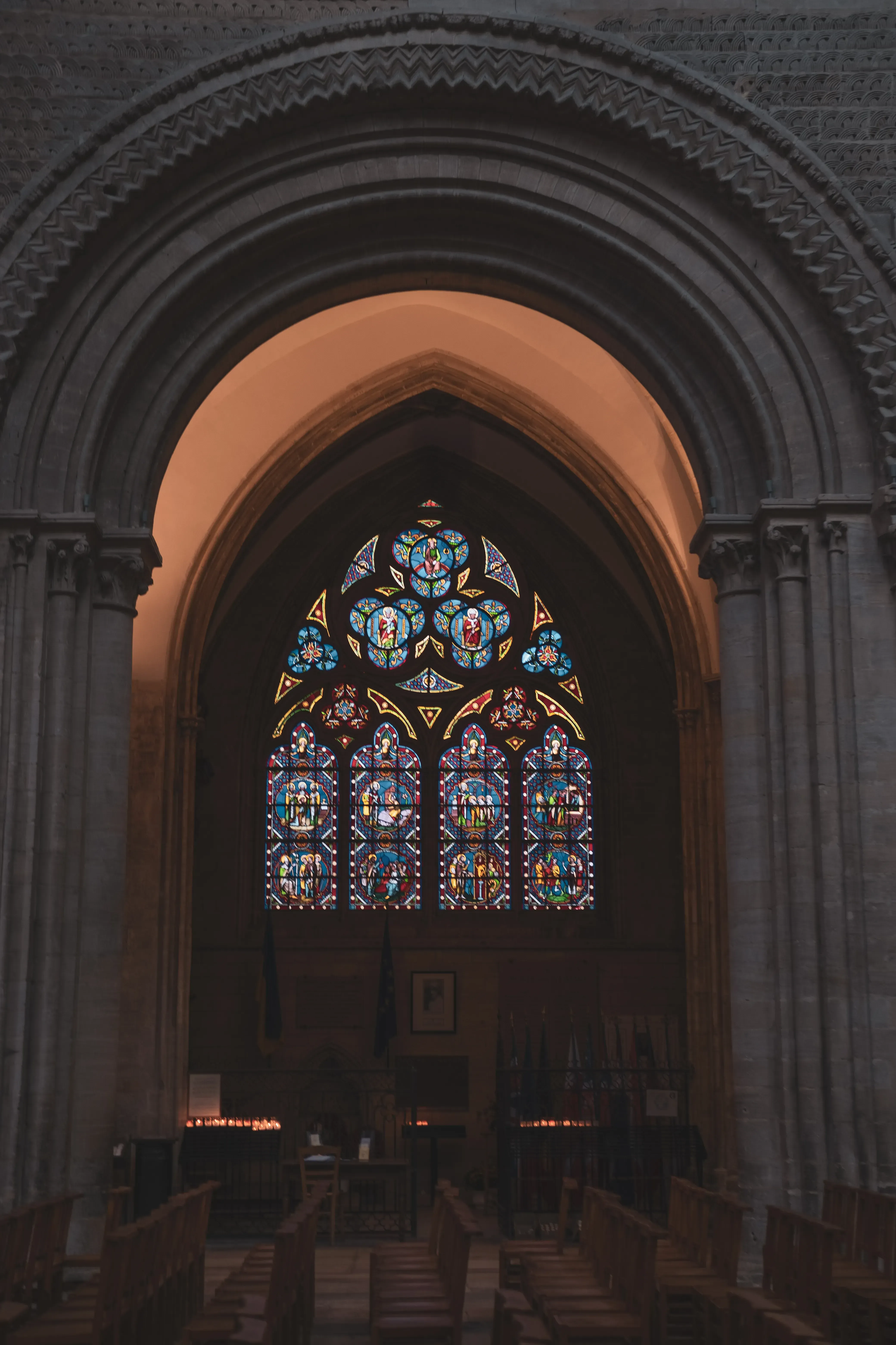 A close-up of a stained glass window or a highly decorated stone window frame within the Abbey.