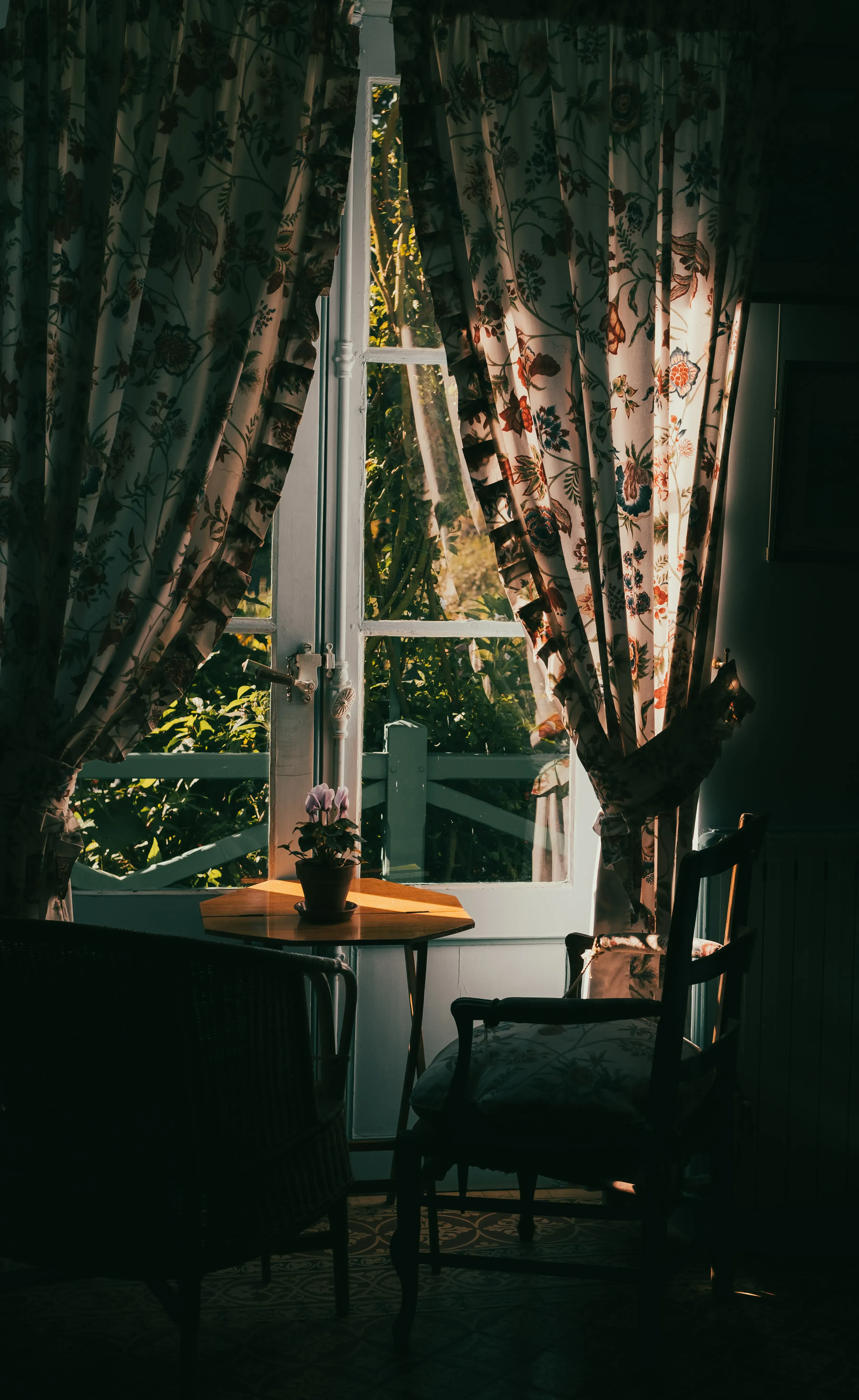 An interior shot showing a small table and a window inside Monet's house.