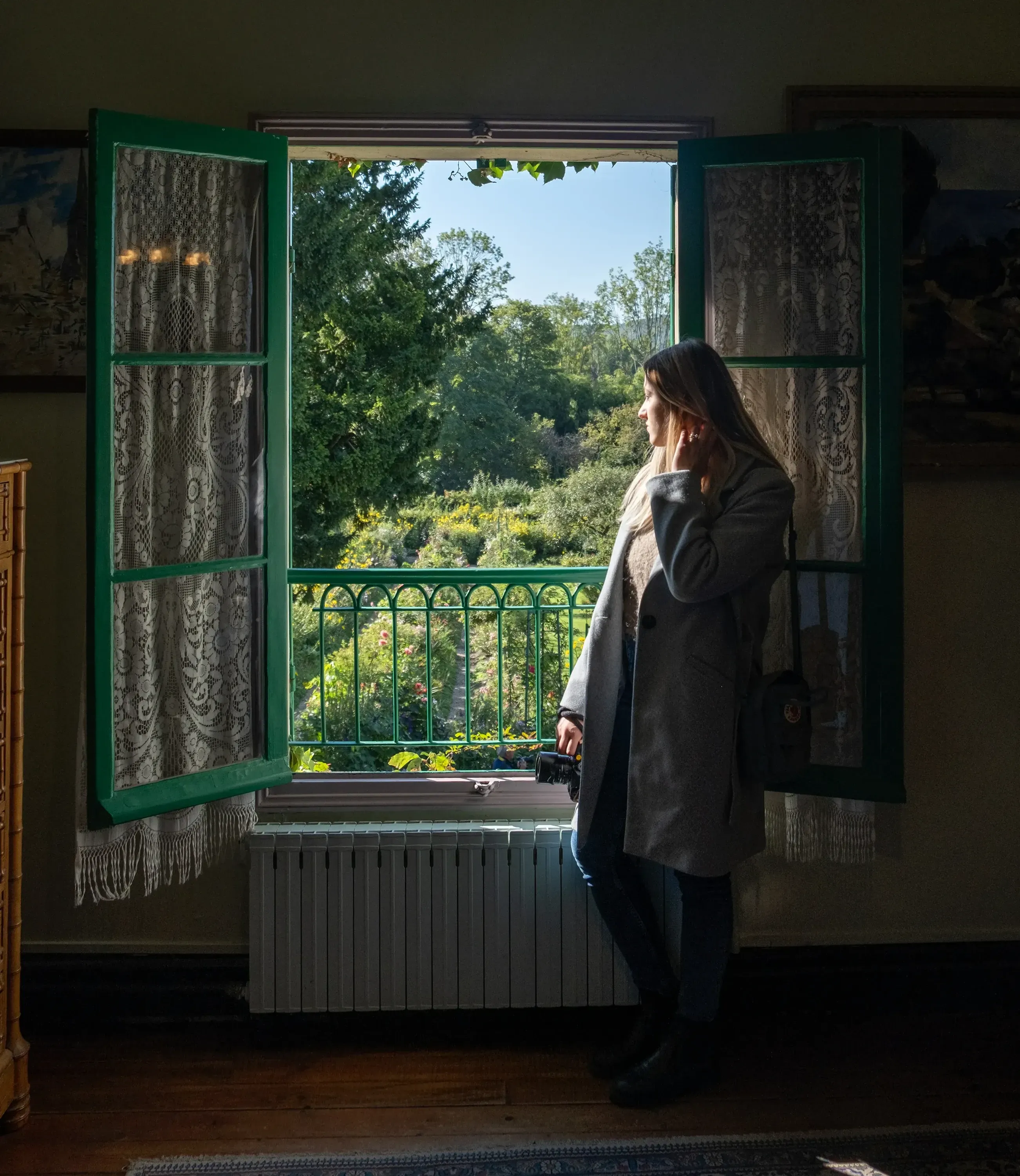 Letizia looking out of a window in the pink and green house of Claude Monet at Giverny.