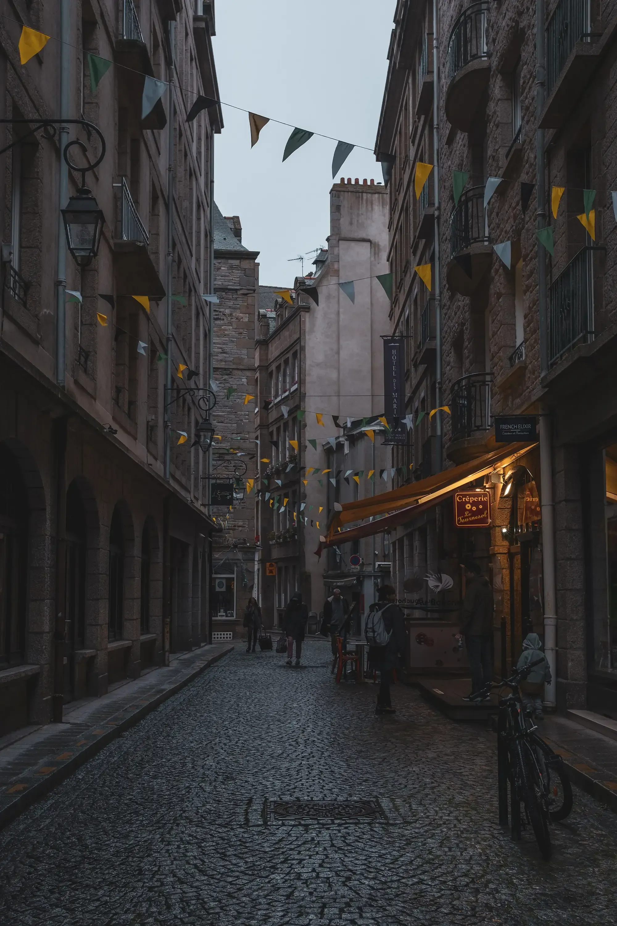 A narrow, stone street within the historic walled city (Intra-Muros) of Saint-Malo, Brittany.