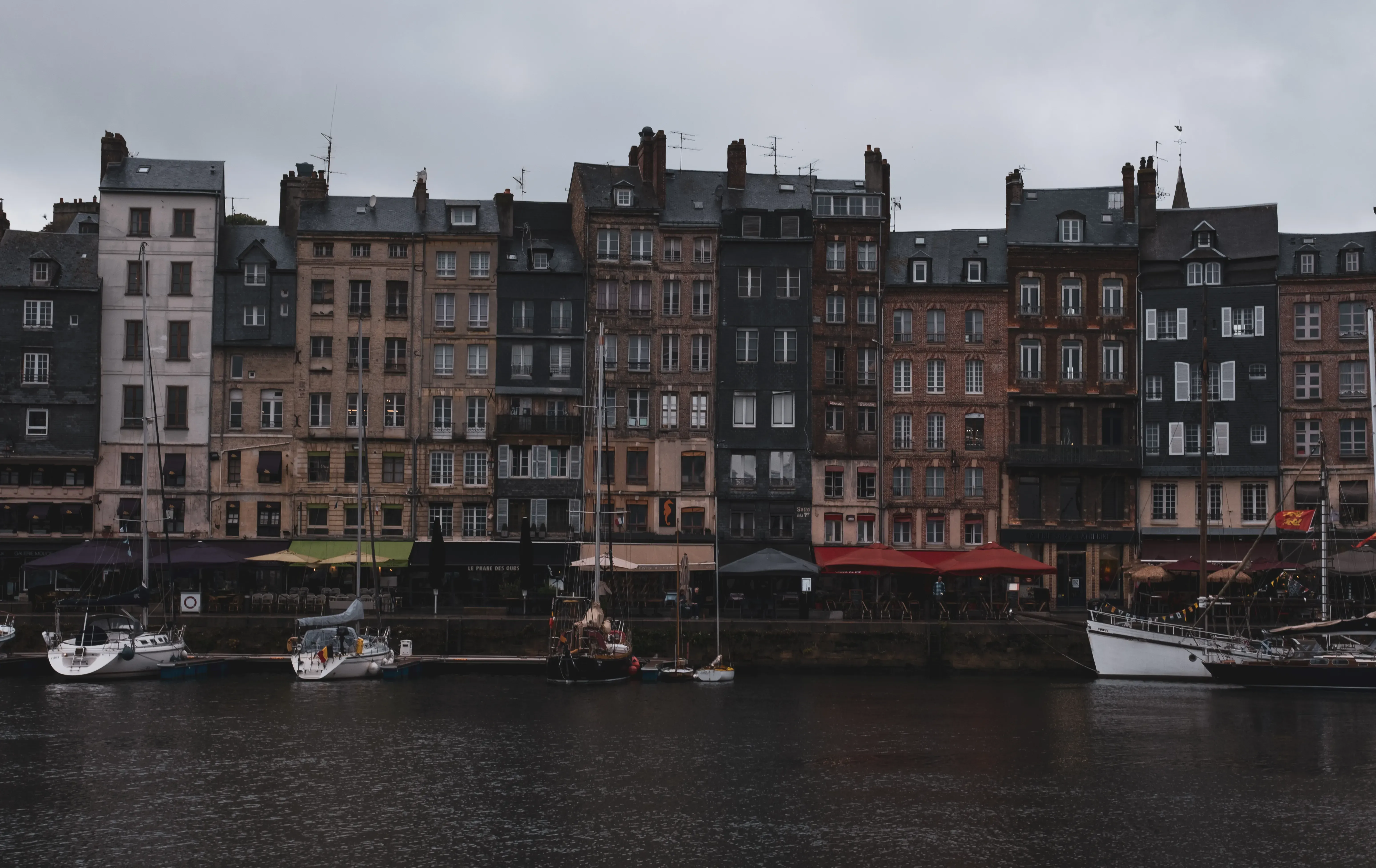 The tall, narrow, half-timbered houses lining the harbor (Vieux Bassin) of Honfleur, Normandy.