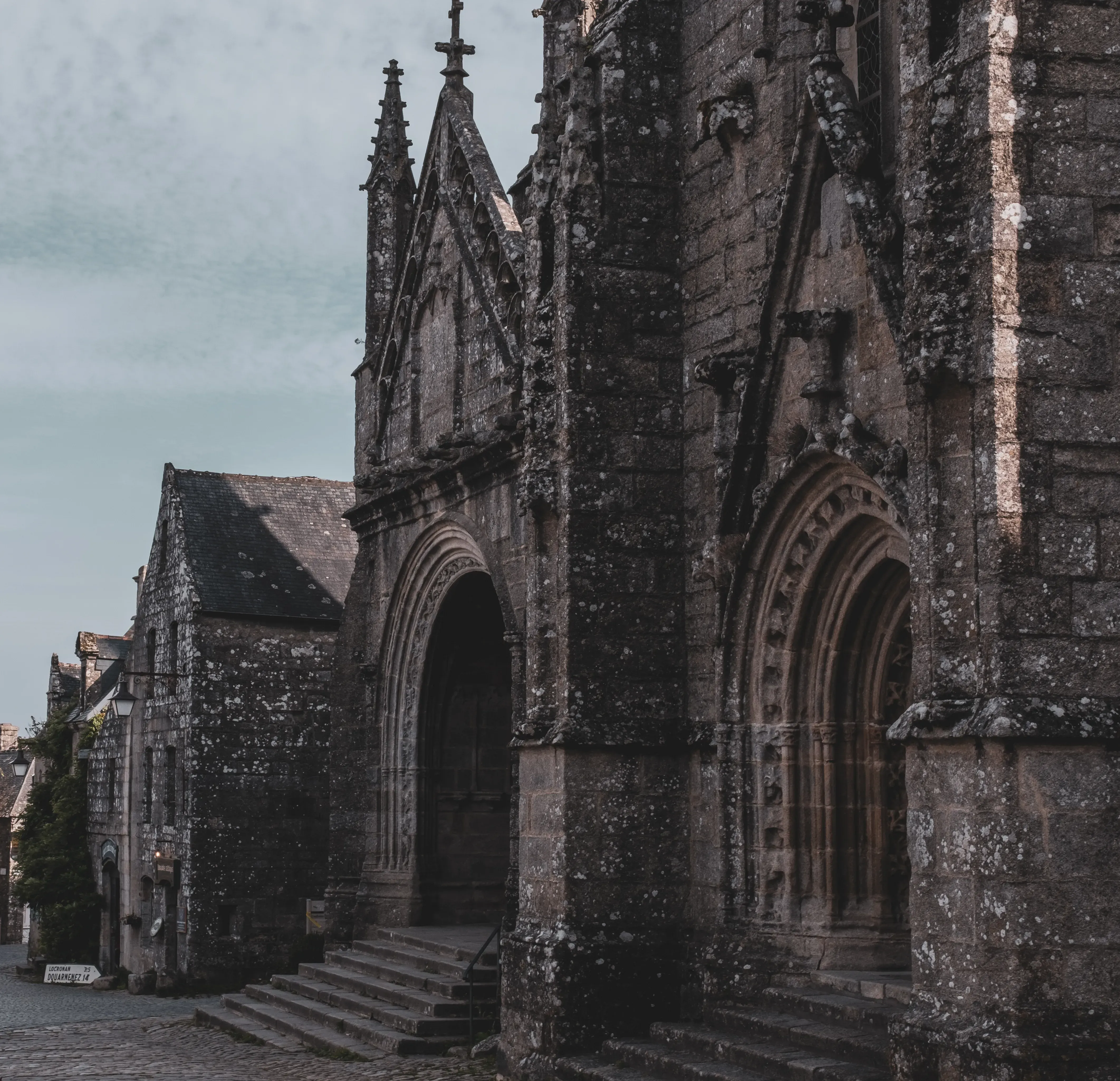 The facade or exterior of the Saint Ronan church in the center of Locronan.