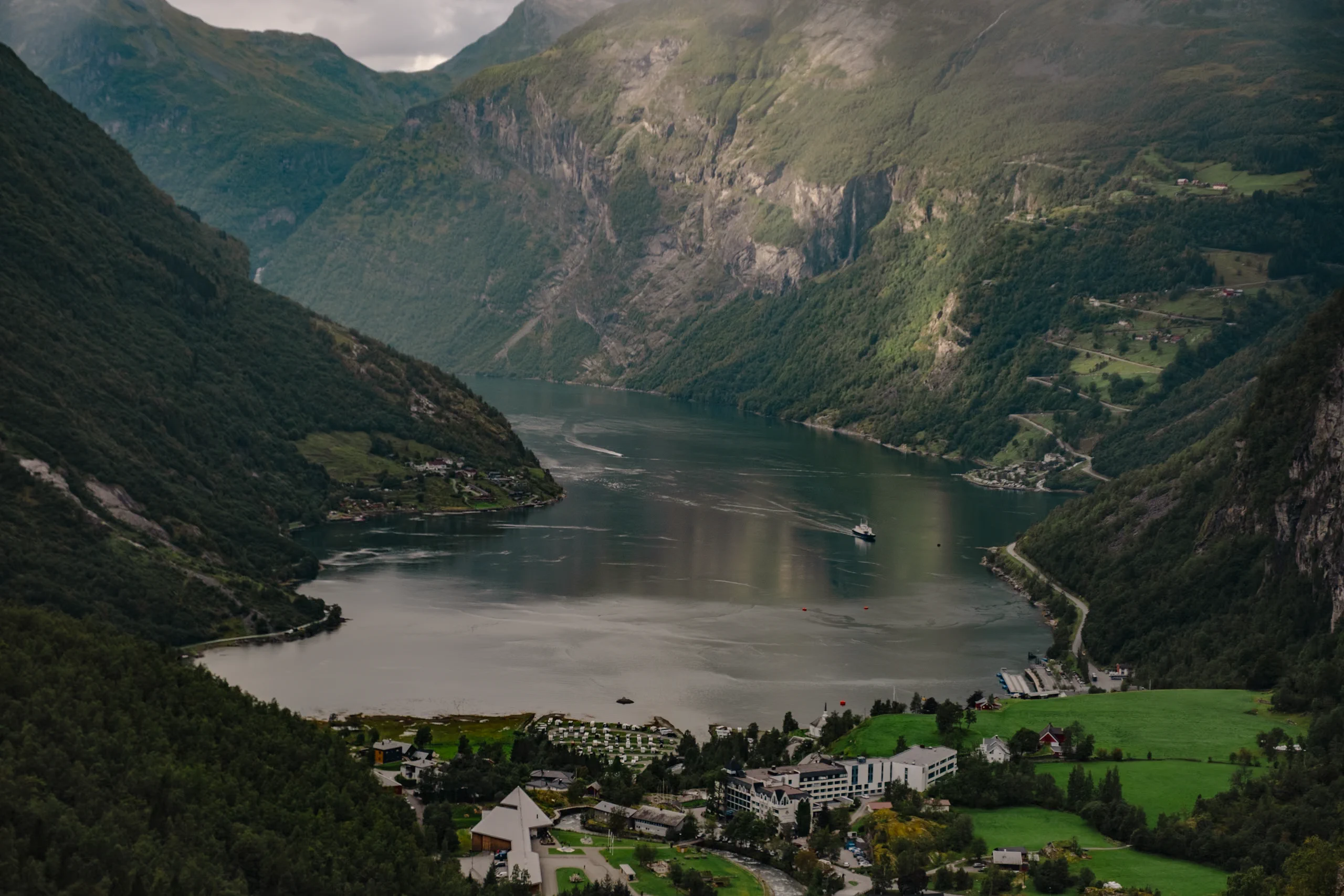 The iconic, wide and deep Geirangerfjord, surrounded by steep cliffs.