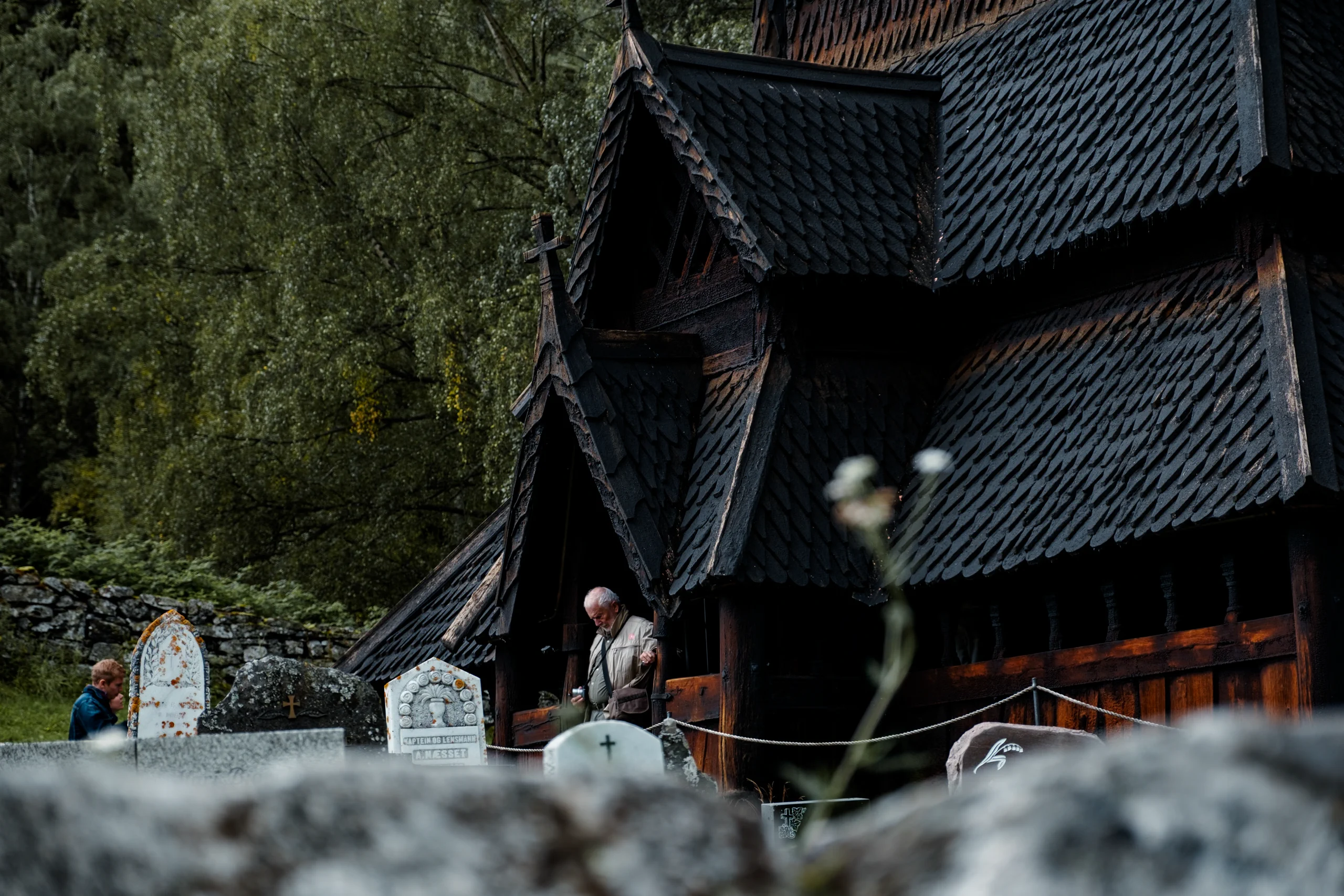 A man coming out from a stave curch