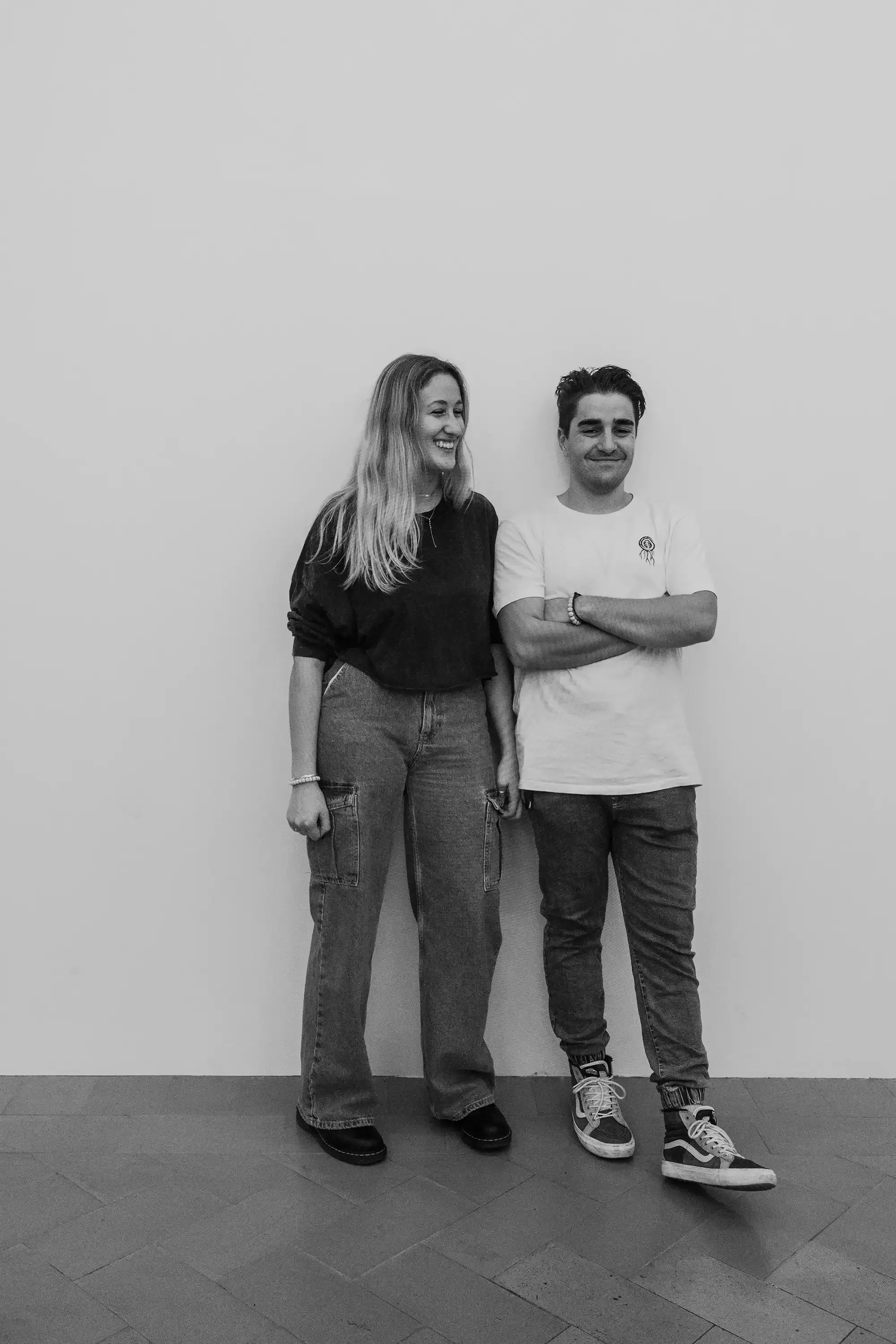 Ieser and Letizia standing together in the light installation room that renders the scene in black and white.