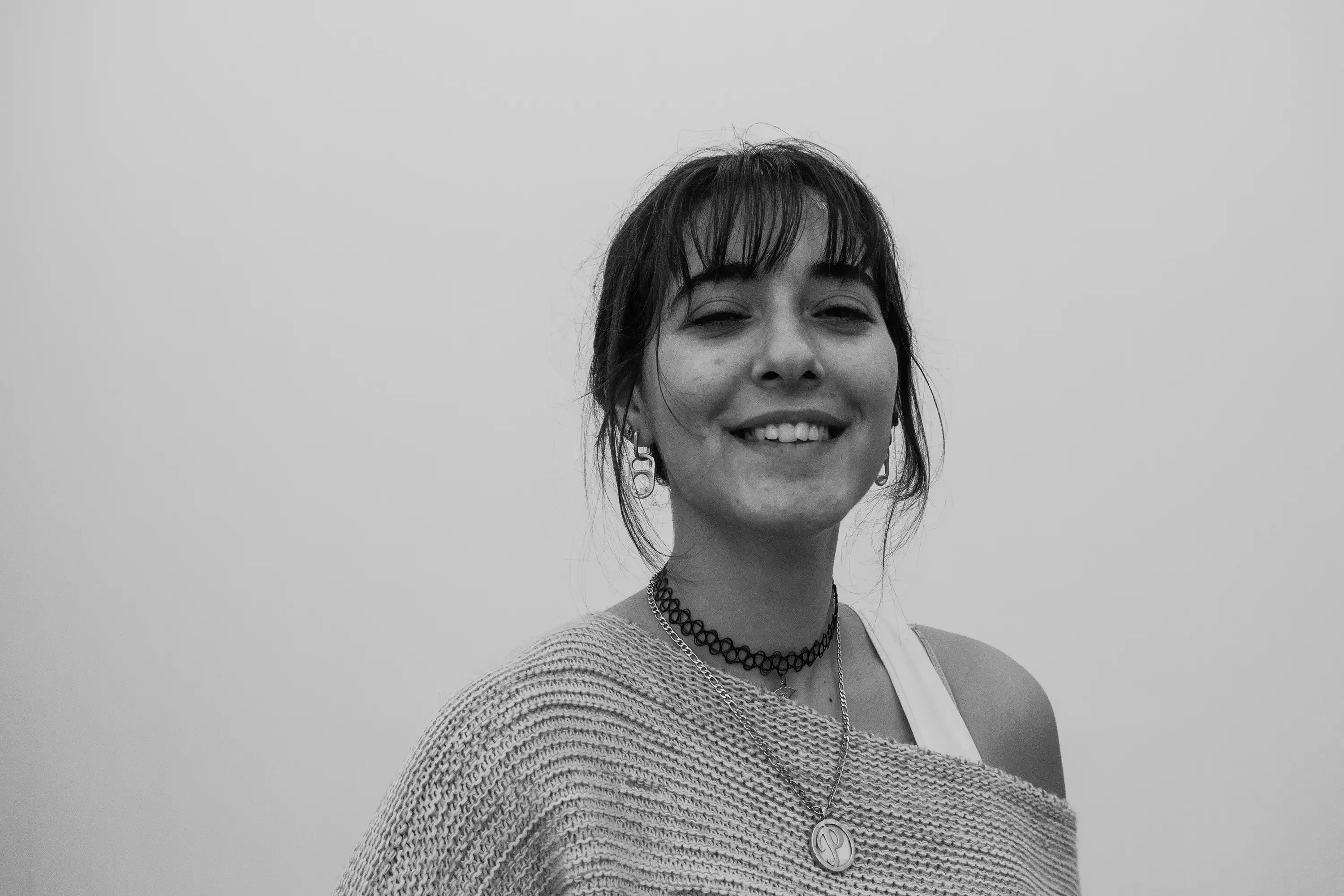 Paulina posing inside a room or hallway that filters light to create a monochromatic (black and white) effect.
