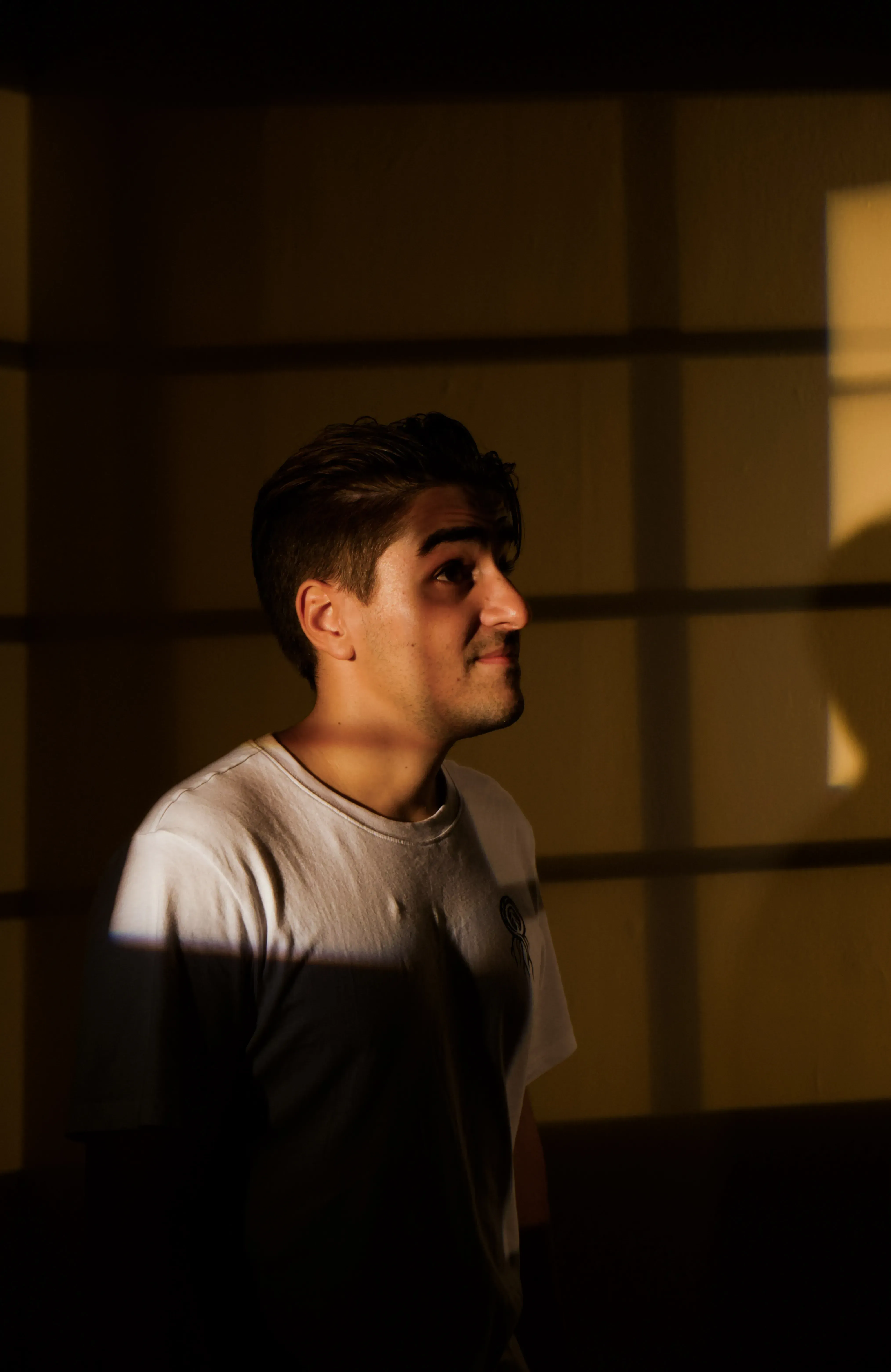 Ieser standing amidst bright, colored lights within the exhibition space.