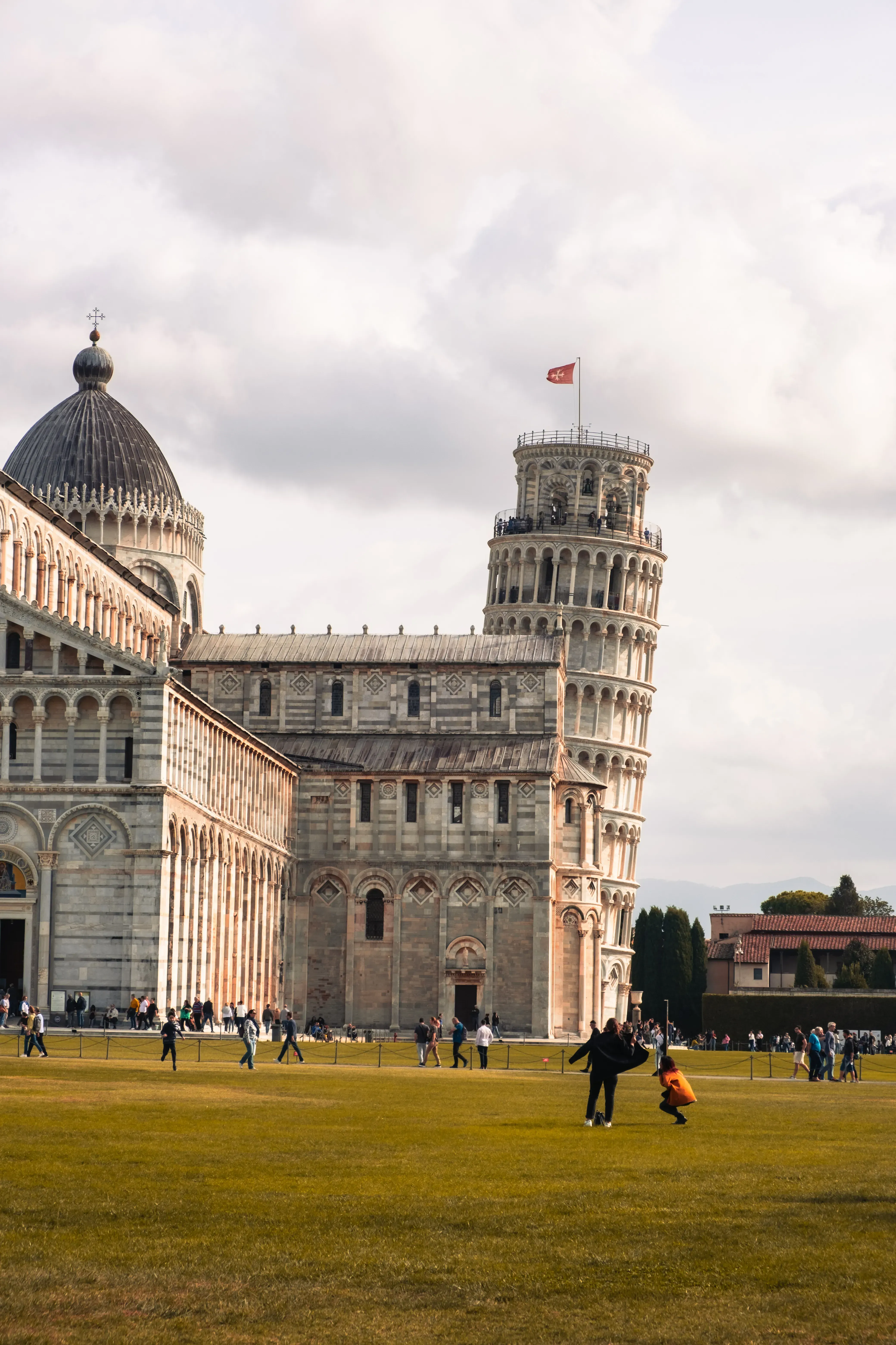 Distant view of the iconic Leaning Tower of Pisa standing in the Piazza dei Miracoli.