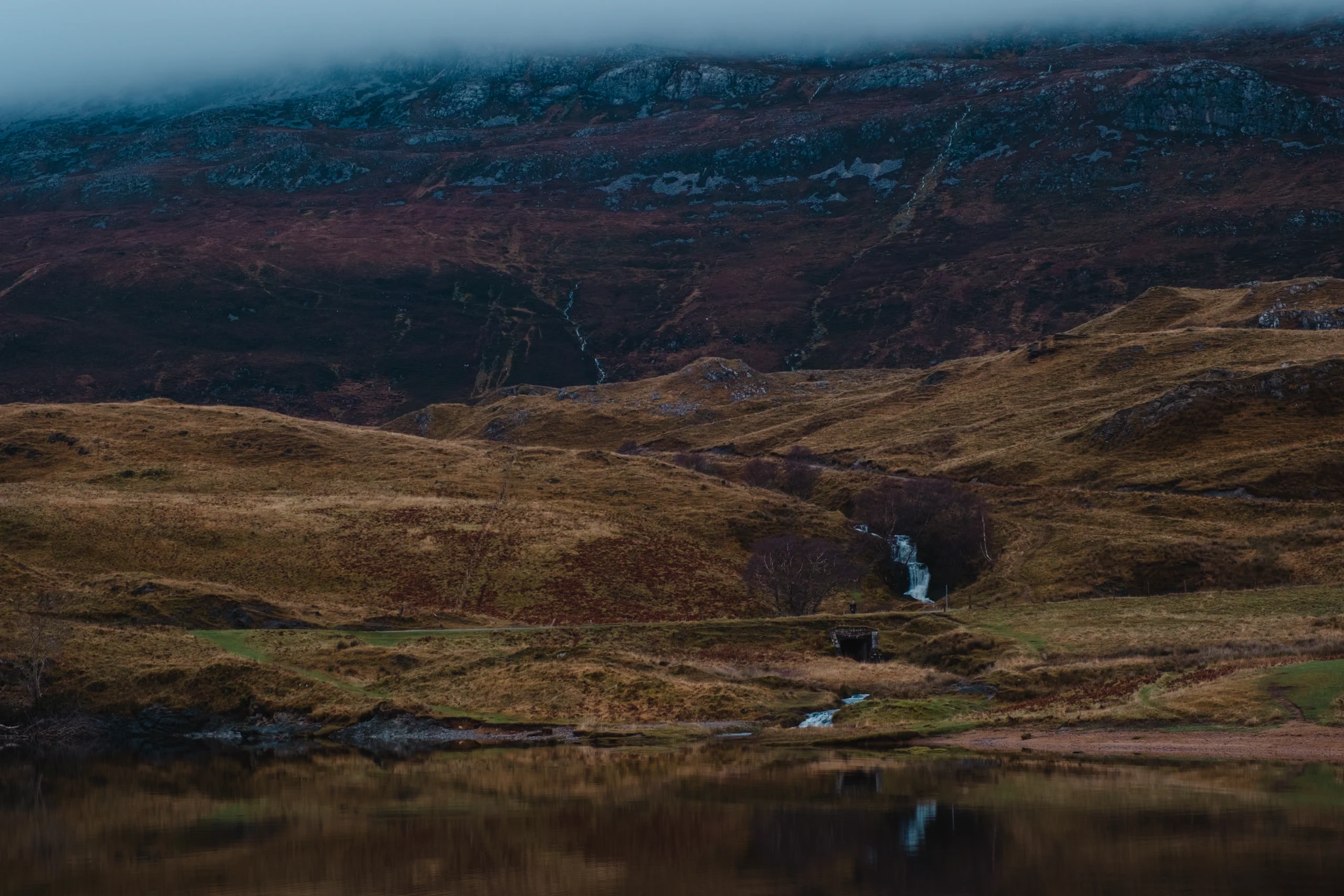 A river flowing through a colorful Scottish landscape.