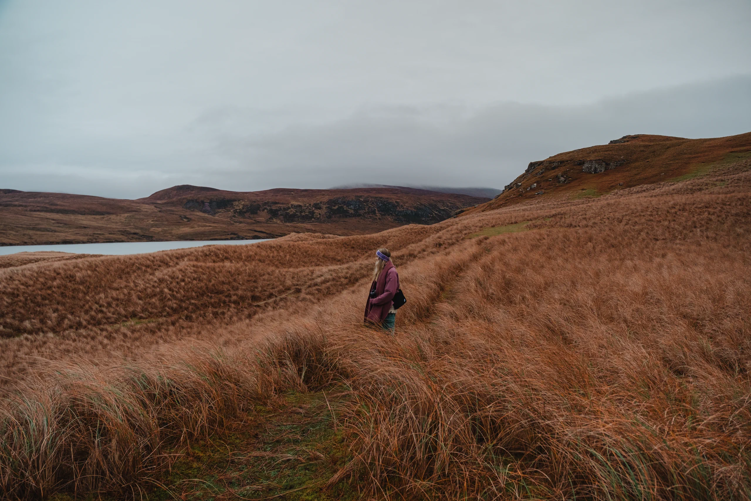 Letizia looking out at the sea from a coastal moor.