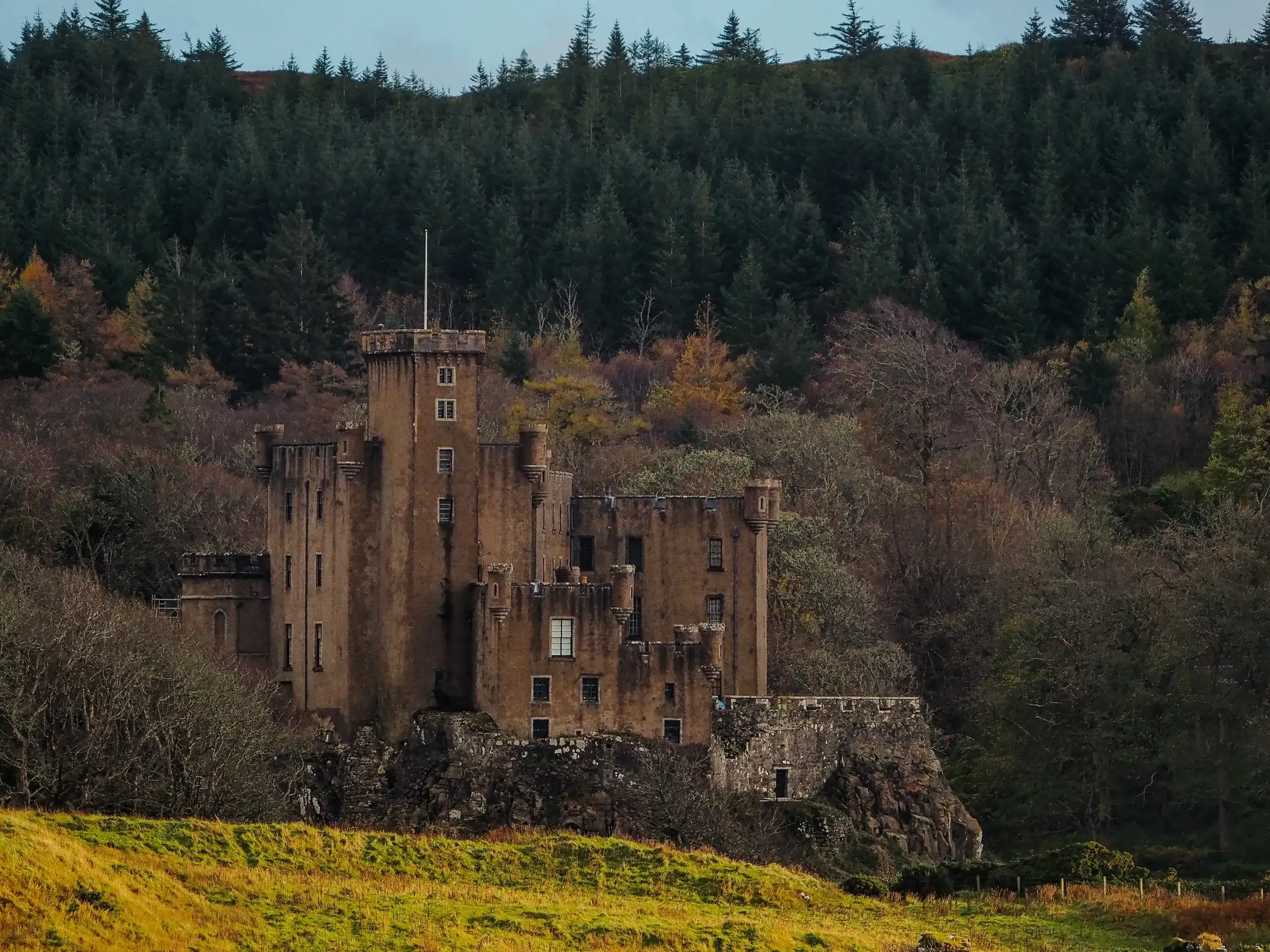 Historic stone castle (e.g., Dunvegan or Eilean Donan) on the Isle of Skye.