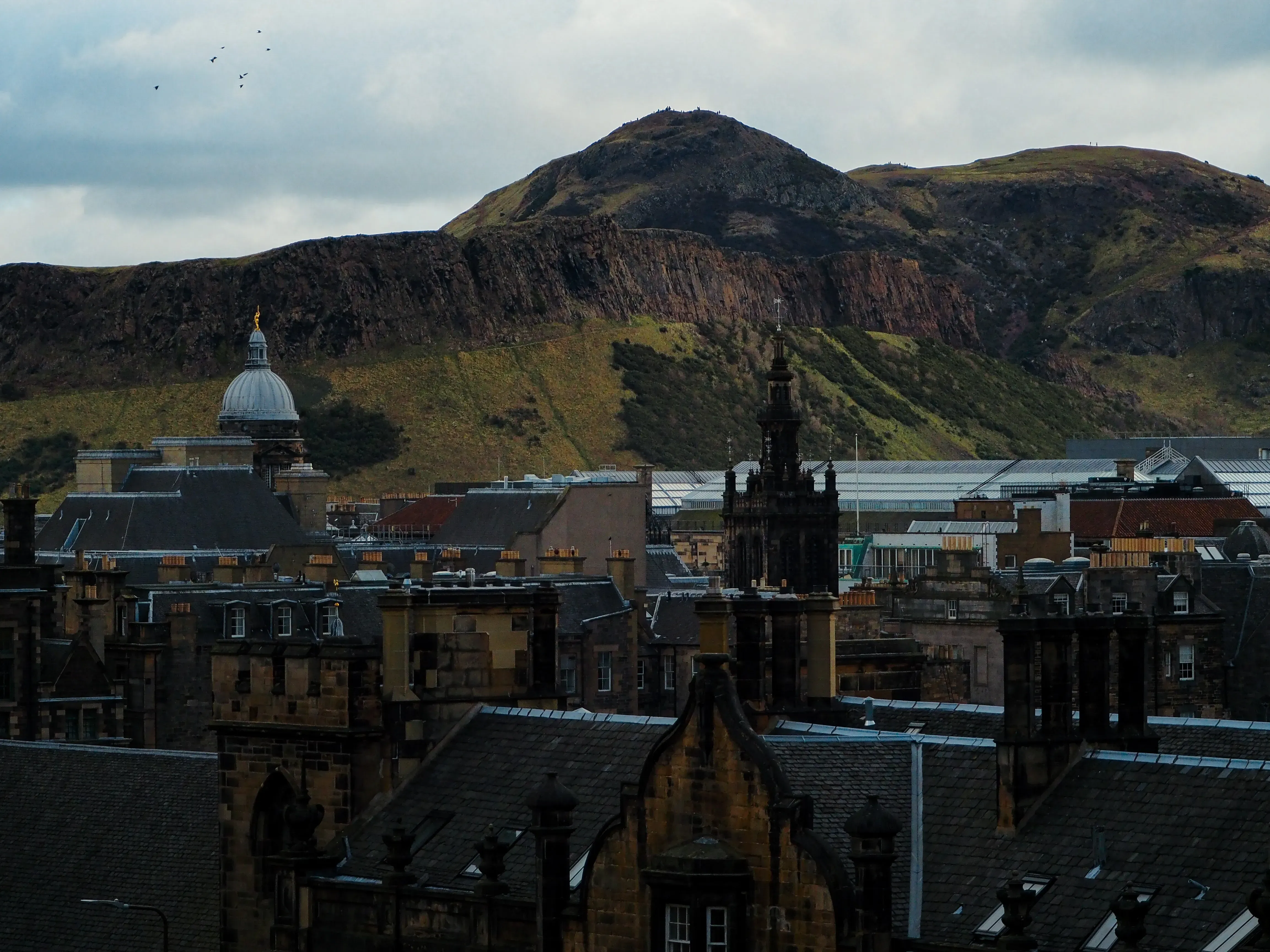 View across the cityscape showing the dark slate roofs of Edinburgh's historic buildings.