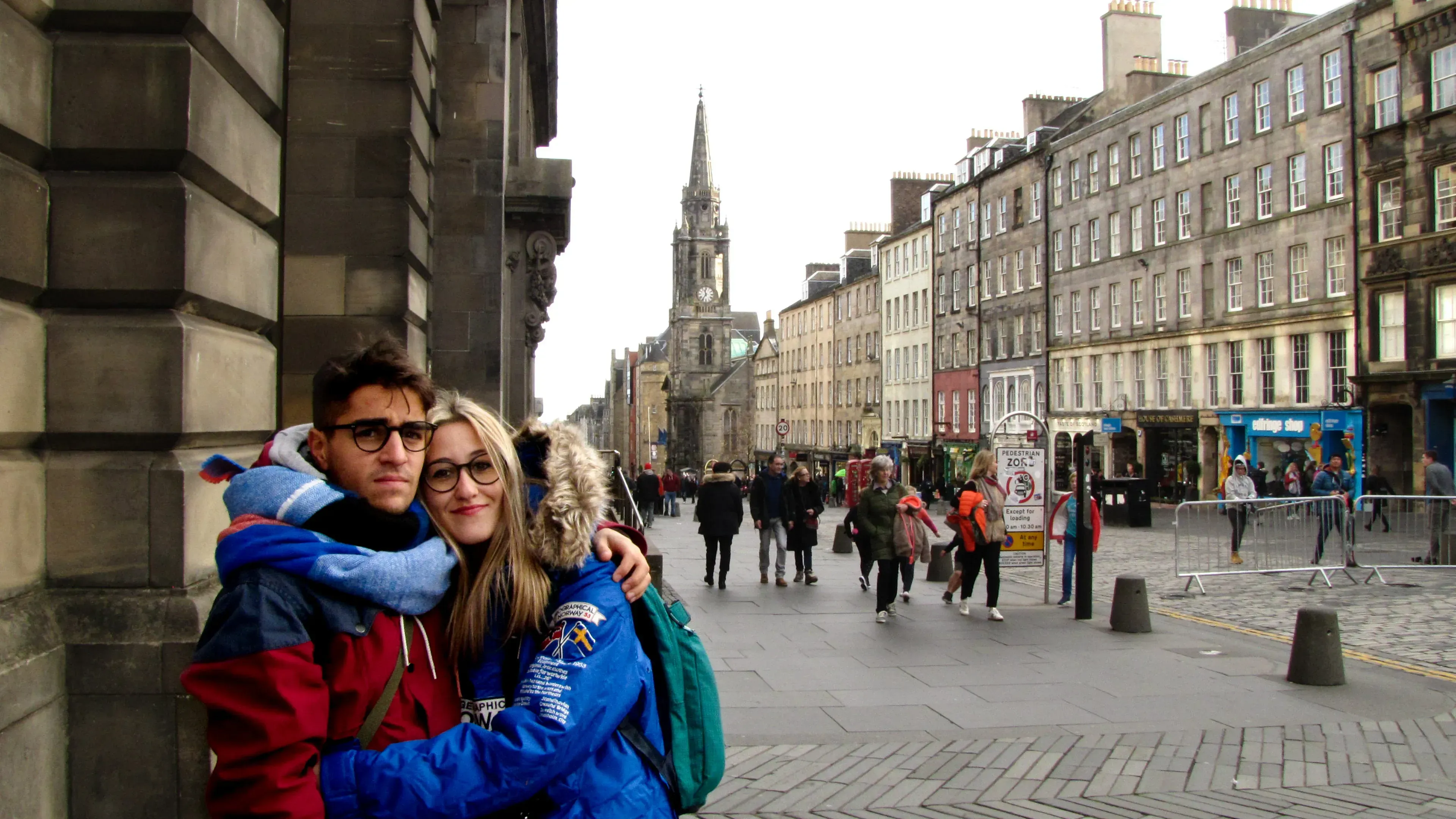 Ieser and Letizia hugging on a historic, cobblestone street in Edinburgh.