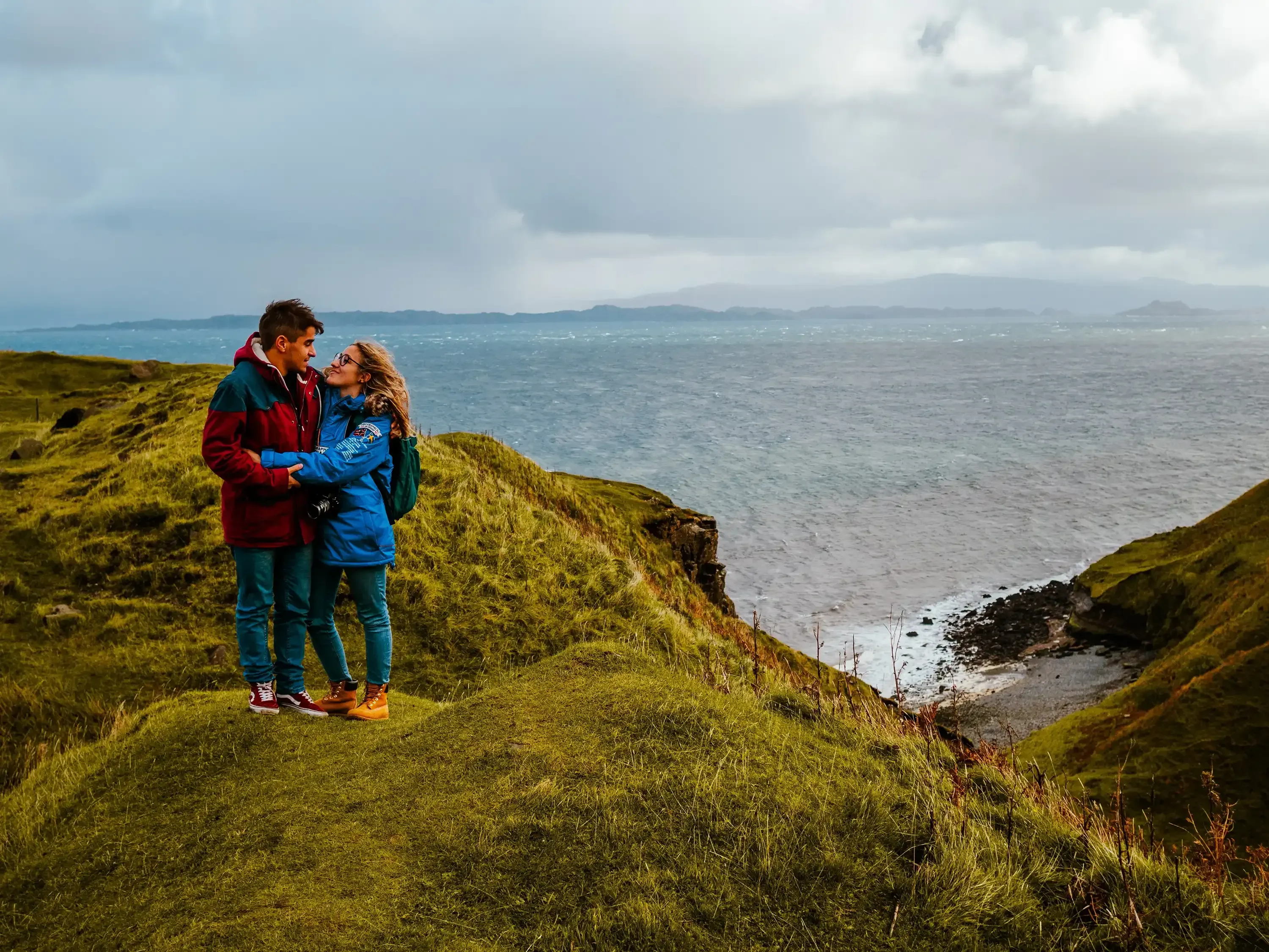 Person and Letizia standing together on the edge of a dramatic Scottish sea cliff.
