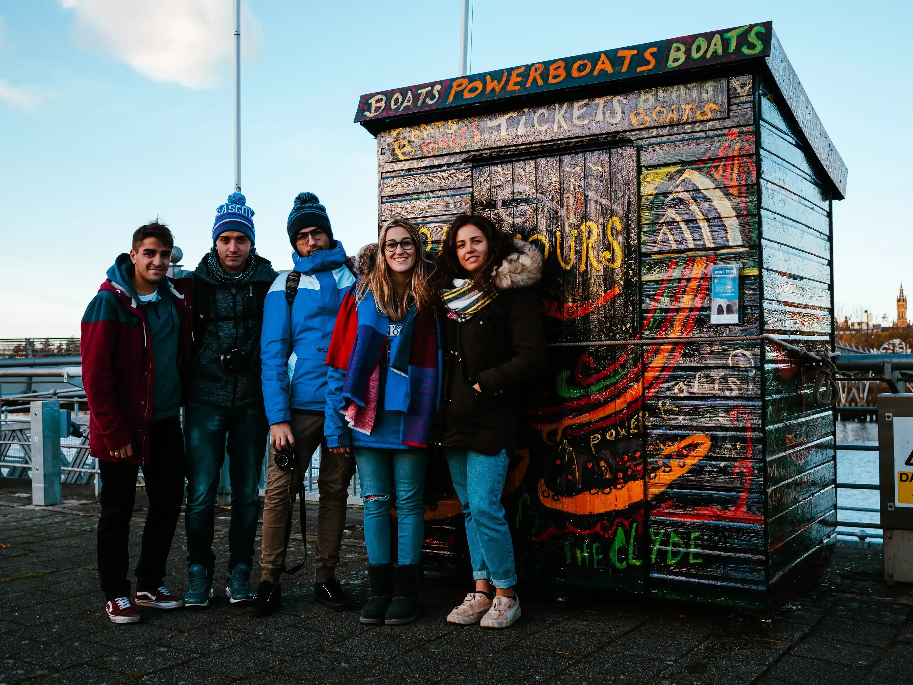 The entire group standing together in front of a landmark building in the city of Glasgow.