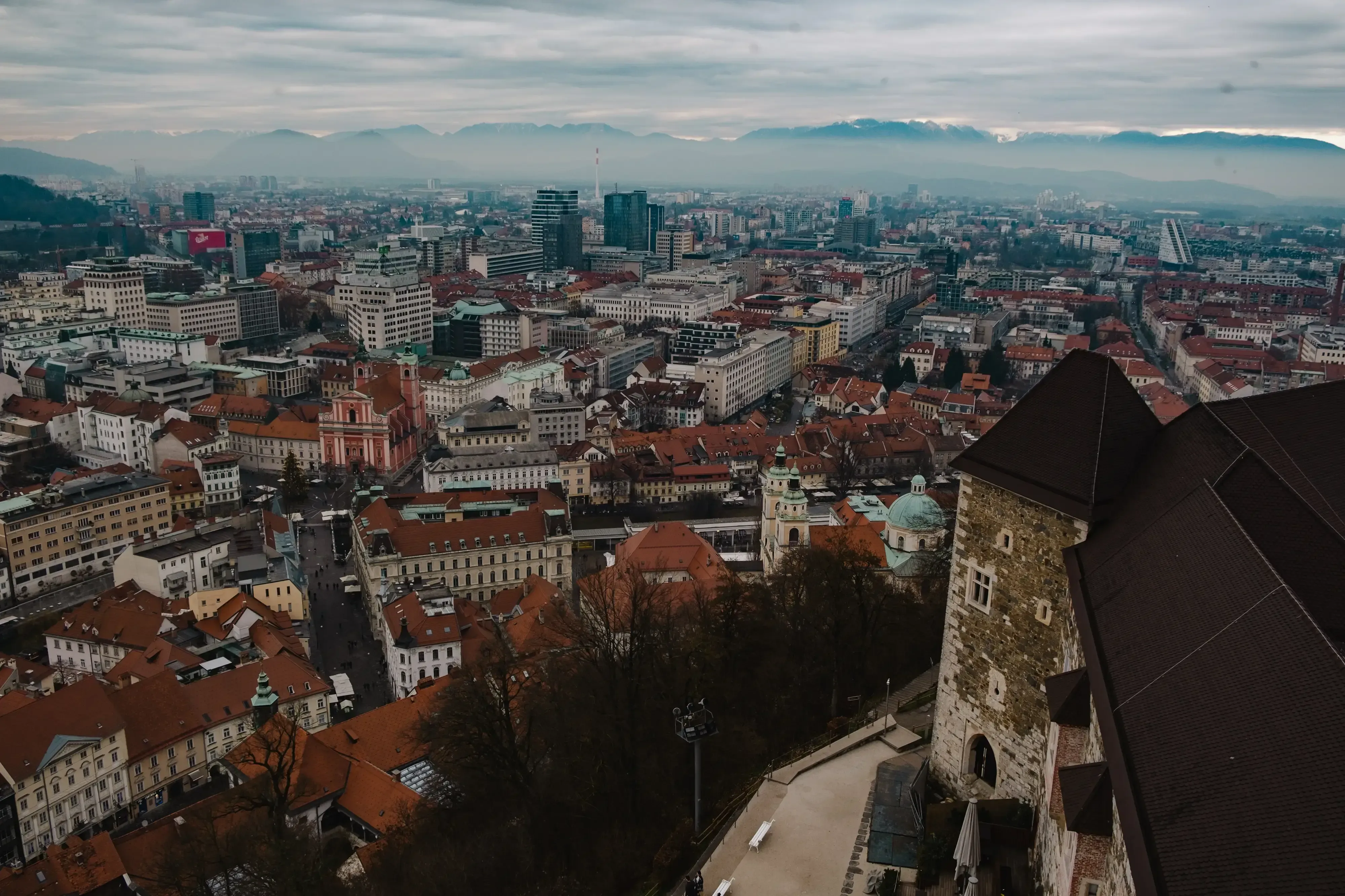 The panoramic view of the red-tiled roofs and city center of Ljubljana as seen from the top of Ljubljana Castle.