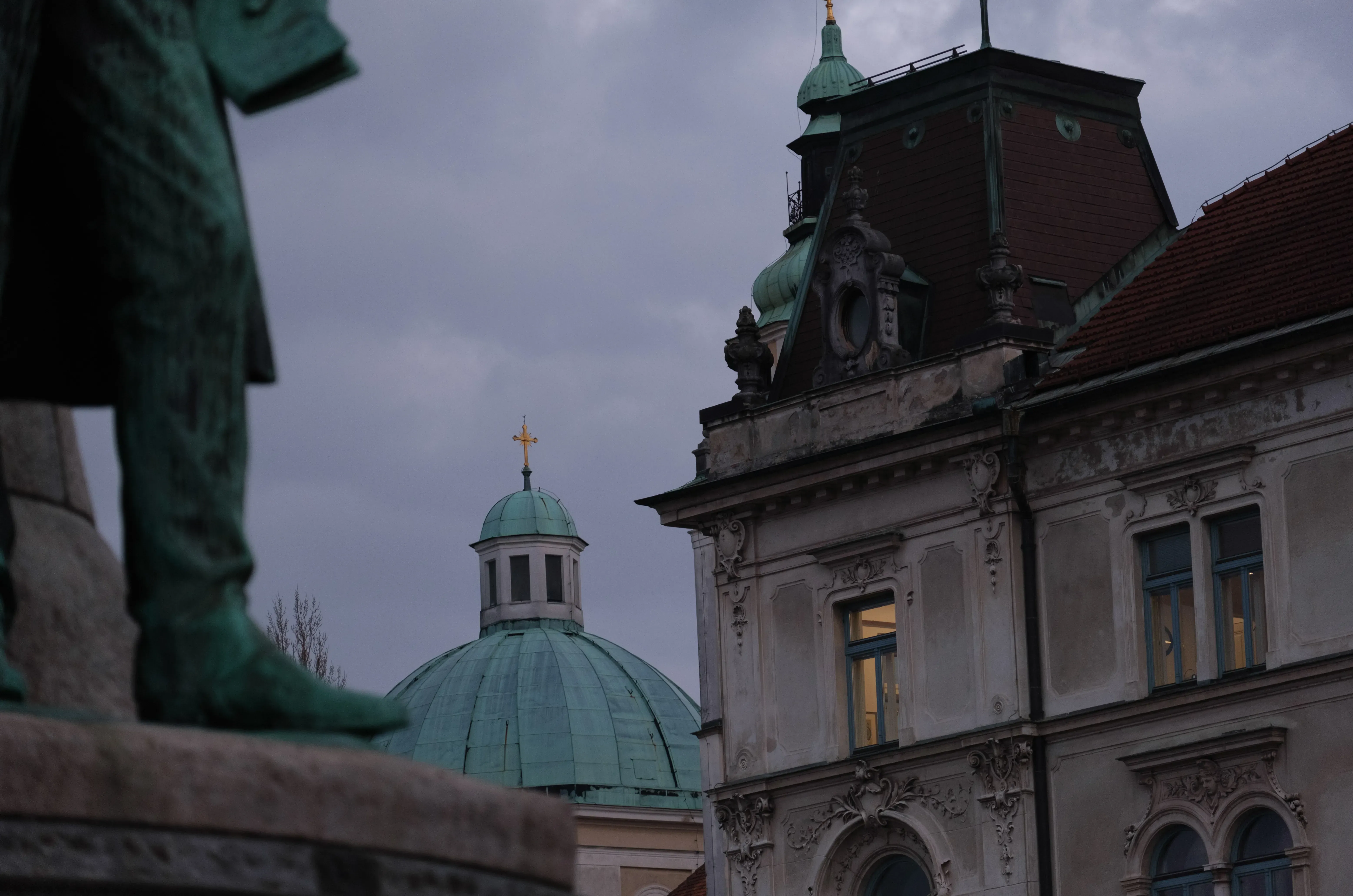 The distinctive dome of a prominent church (e.g., St. Nicholas Cathedral) standing out among the rooftops of Ljubljana.