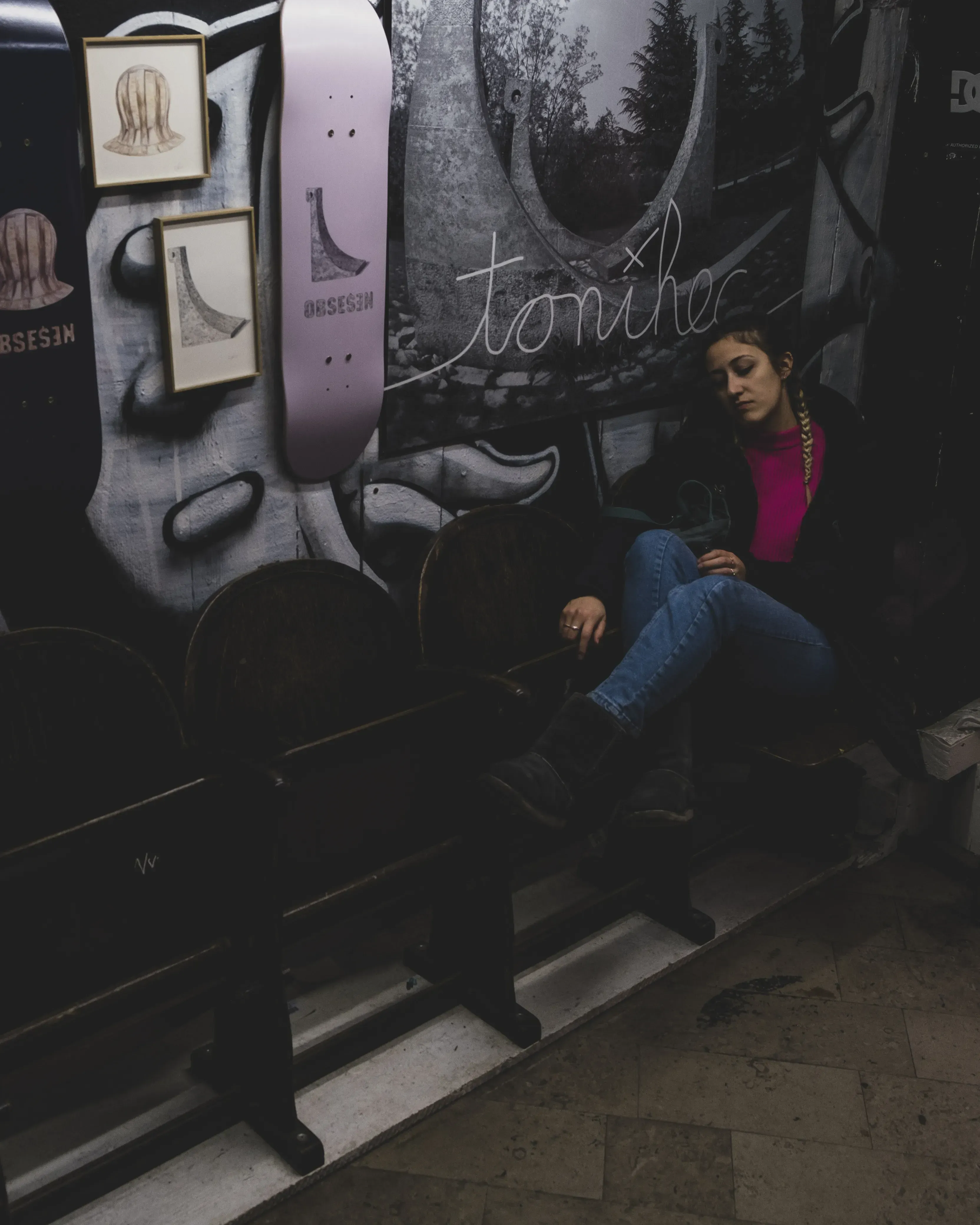 Letizia sitting inside or outside a cozy cafe or bar in the city center.