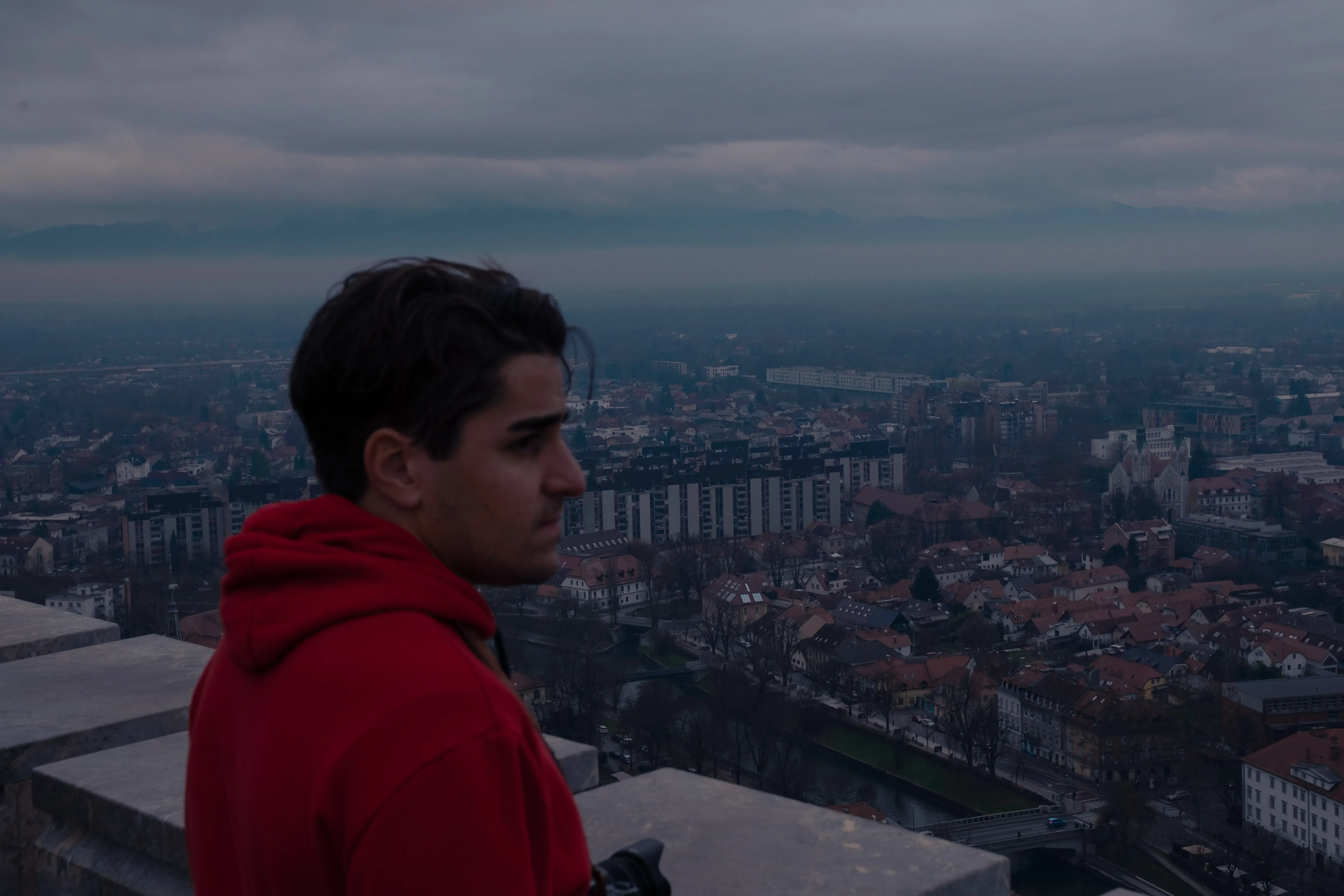 Ieser standing with the historic skyline and Baroque buildings of Ljubljana visible in the background.