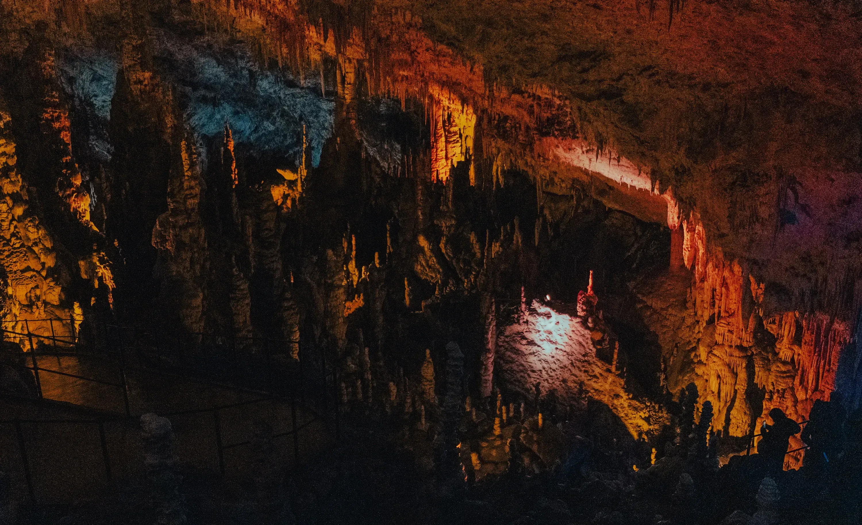 View of the illuminated main chamber and pathways deep inside the vast Postojna Cave system.