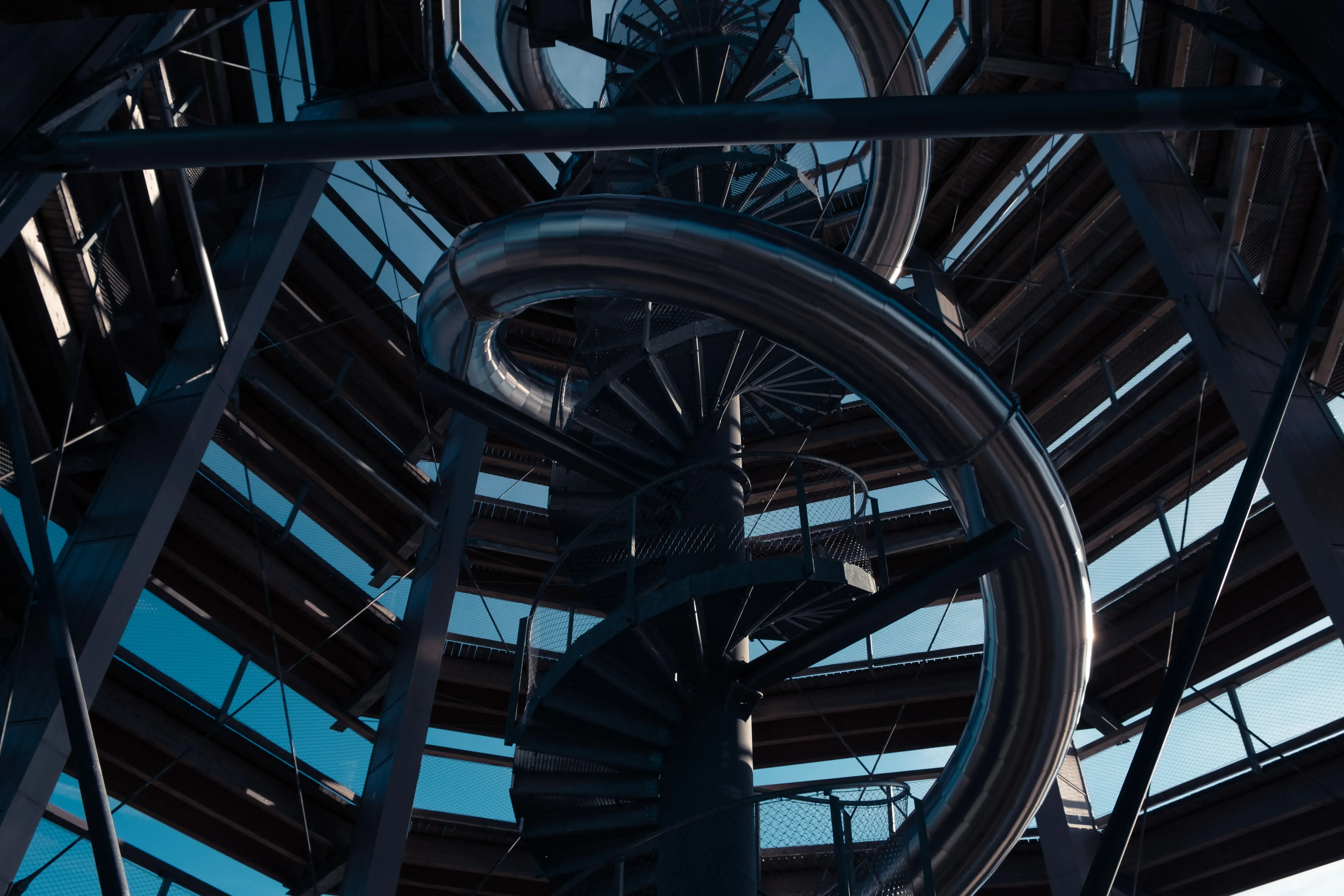 The base of the large, spiraling slide attached to the Rogla walkway, viewed from the ground below.