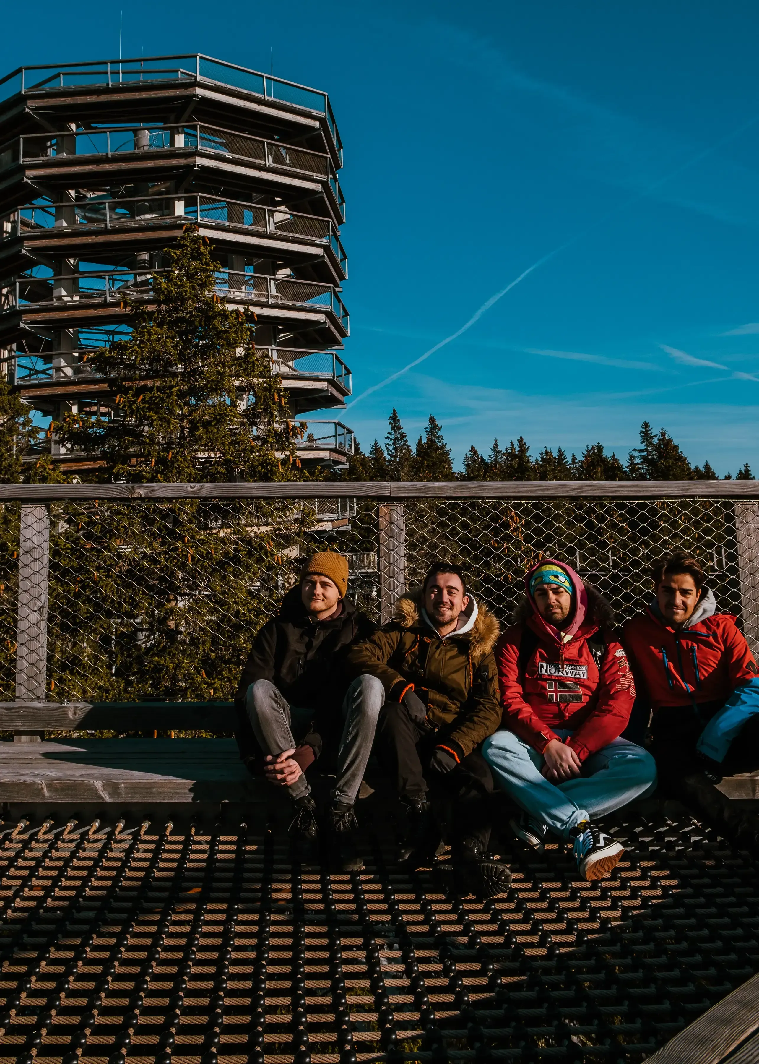 Ieser, Iair, and Mattis posing together near the entrance or exit of the spiral slide at the Treetop Walk.