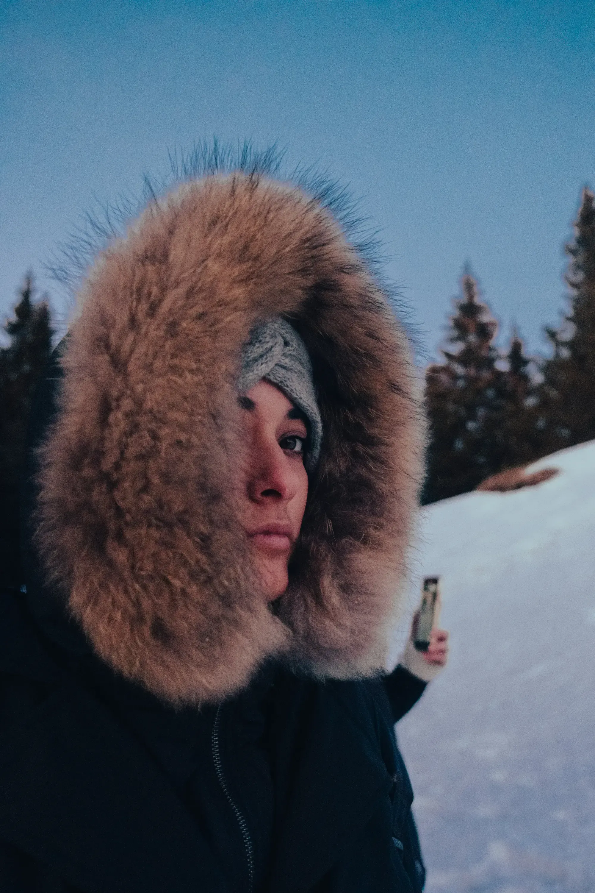 Paulina bundled up in a heavy coat, standing in the chilly, high-altitude landscape of Rogla.
