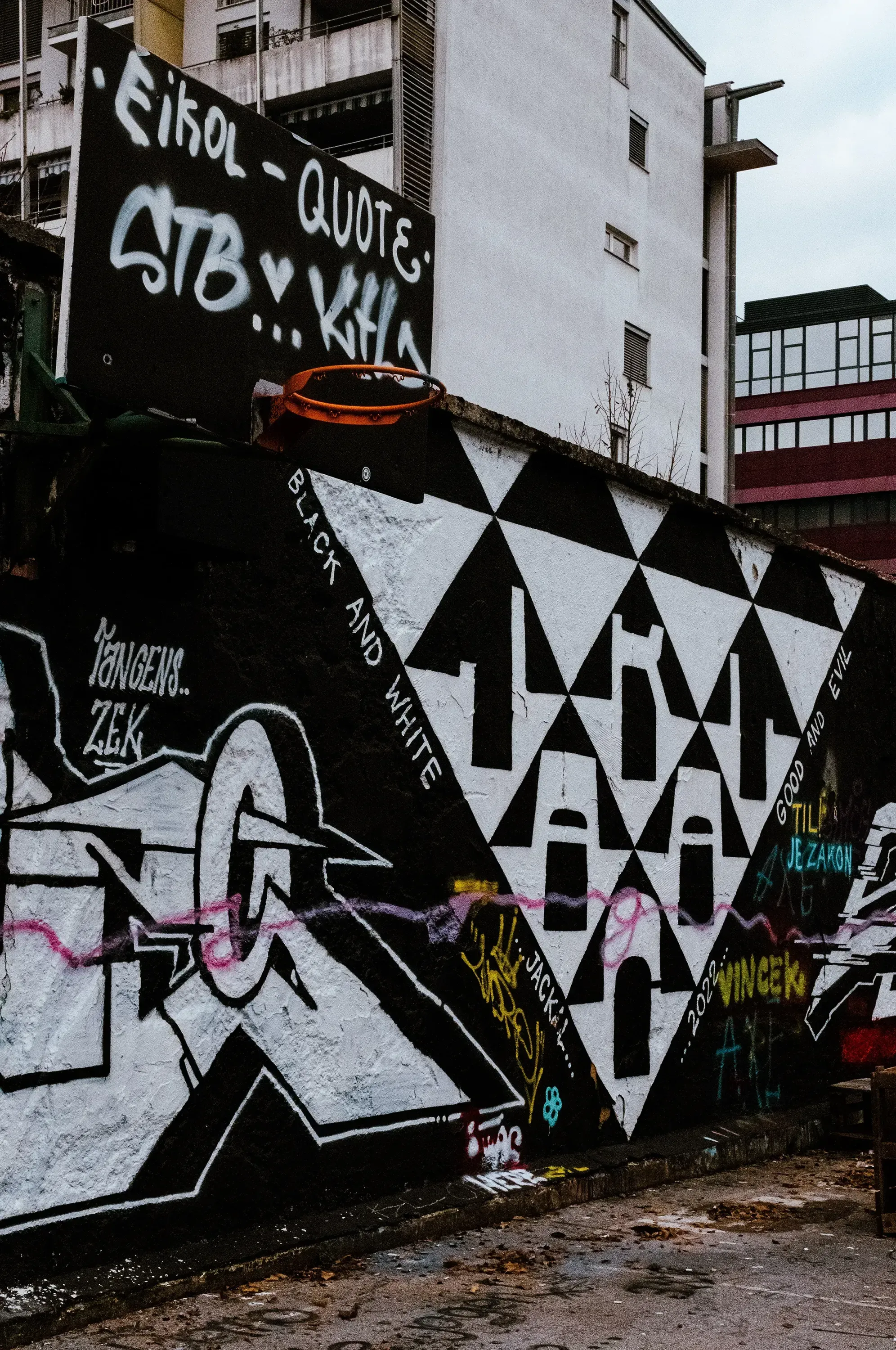 A close-up or wide shot of the elaborate, colorful street art and graffiti covering the walls of the buildings in Metelkova.