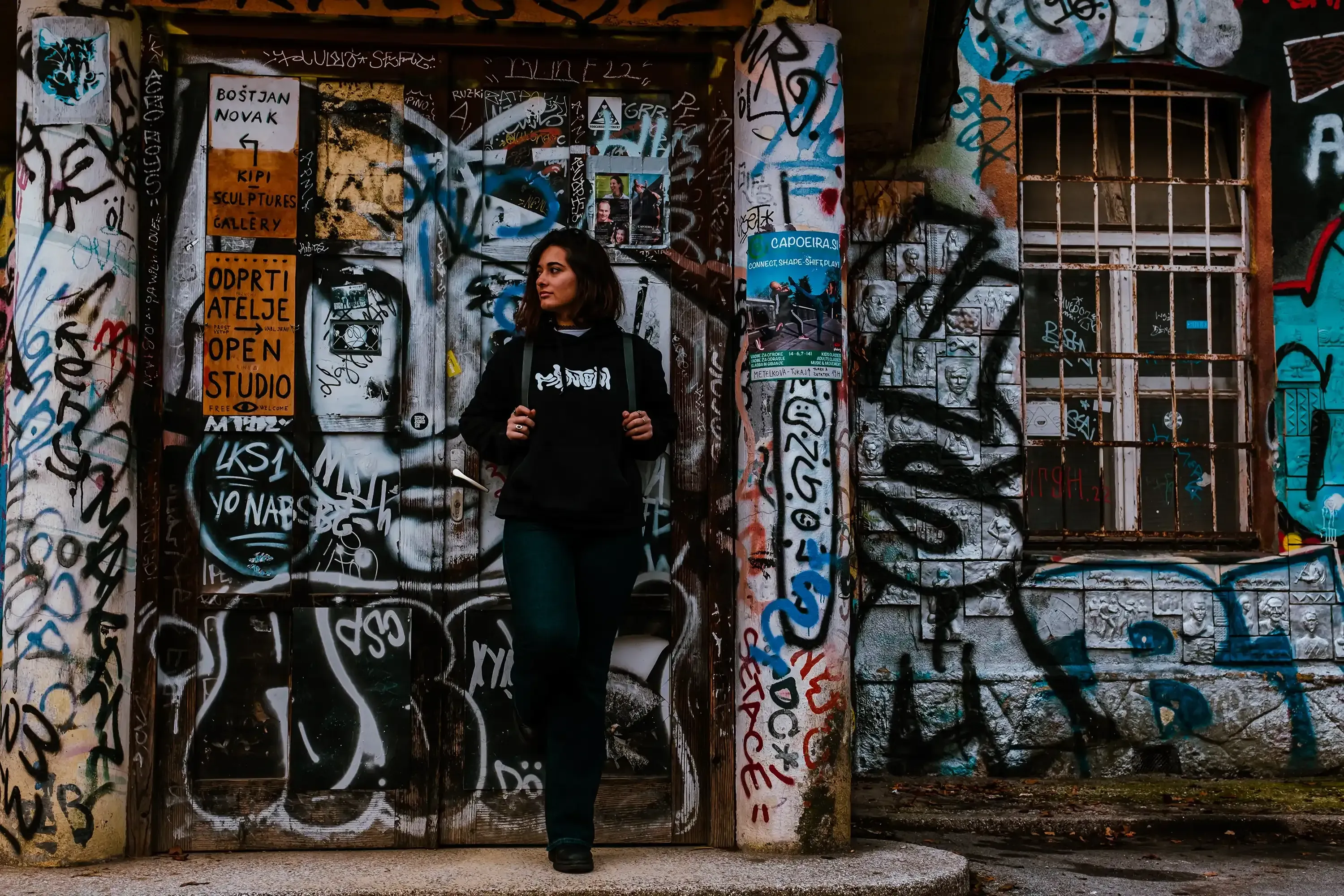 Paulina standing in front of a specific doorway in Metelkova.