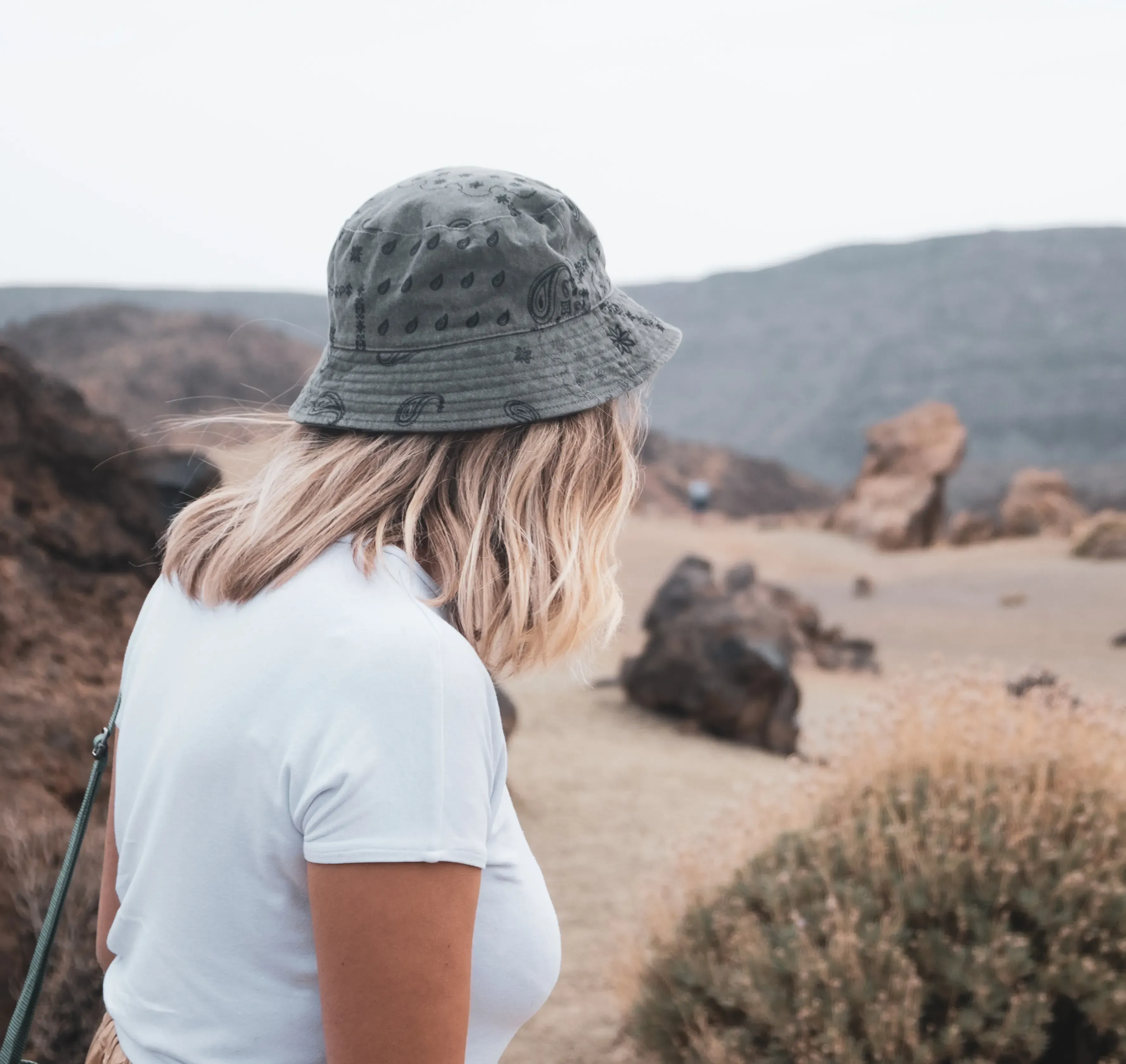 Letizia walking along a trail through the high-altitude, desolate, moon-like landscape of the Teide National Park.